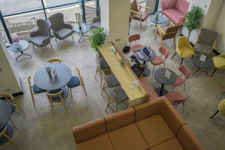 A person working on a laptop at a high counter in a lounge