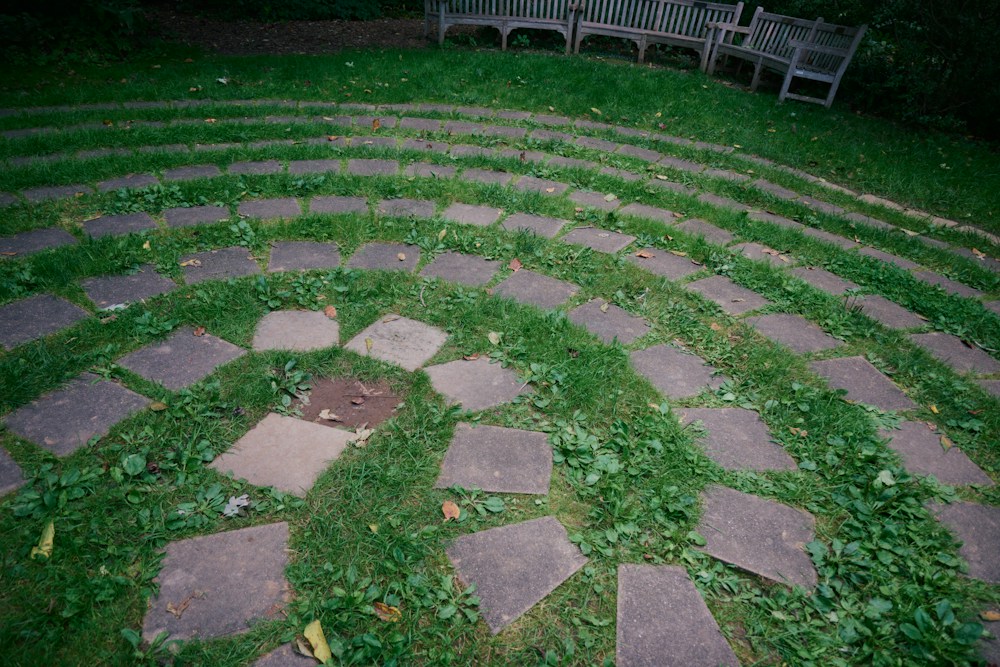 Stone circle path set into a lawn with benches