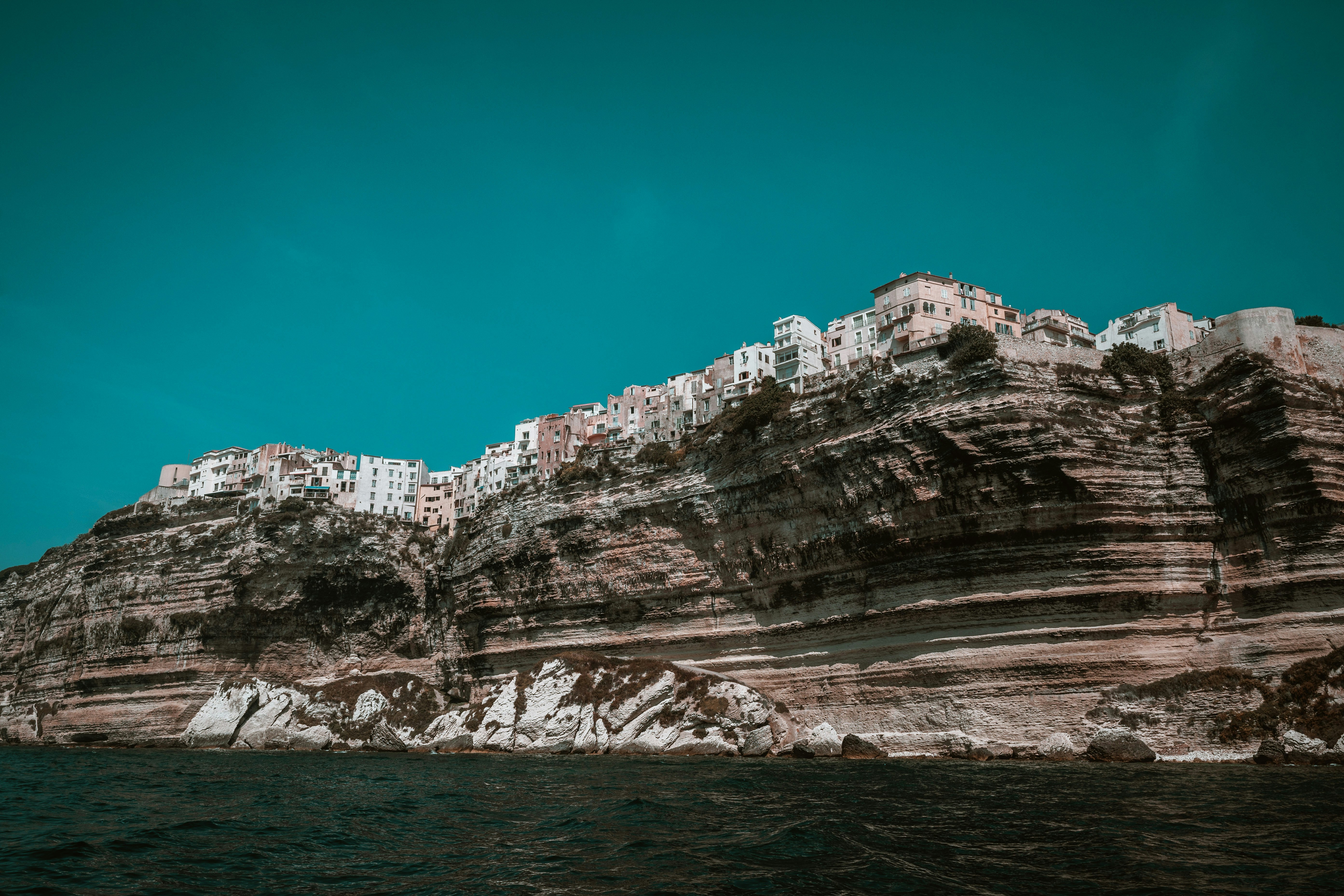 Buildings perched on a high limestone cliff above the sea in Bonifacio, Corsica