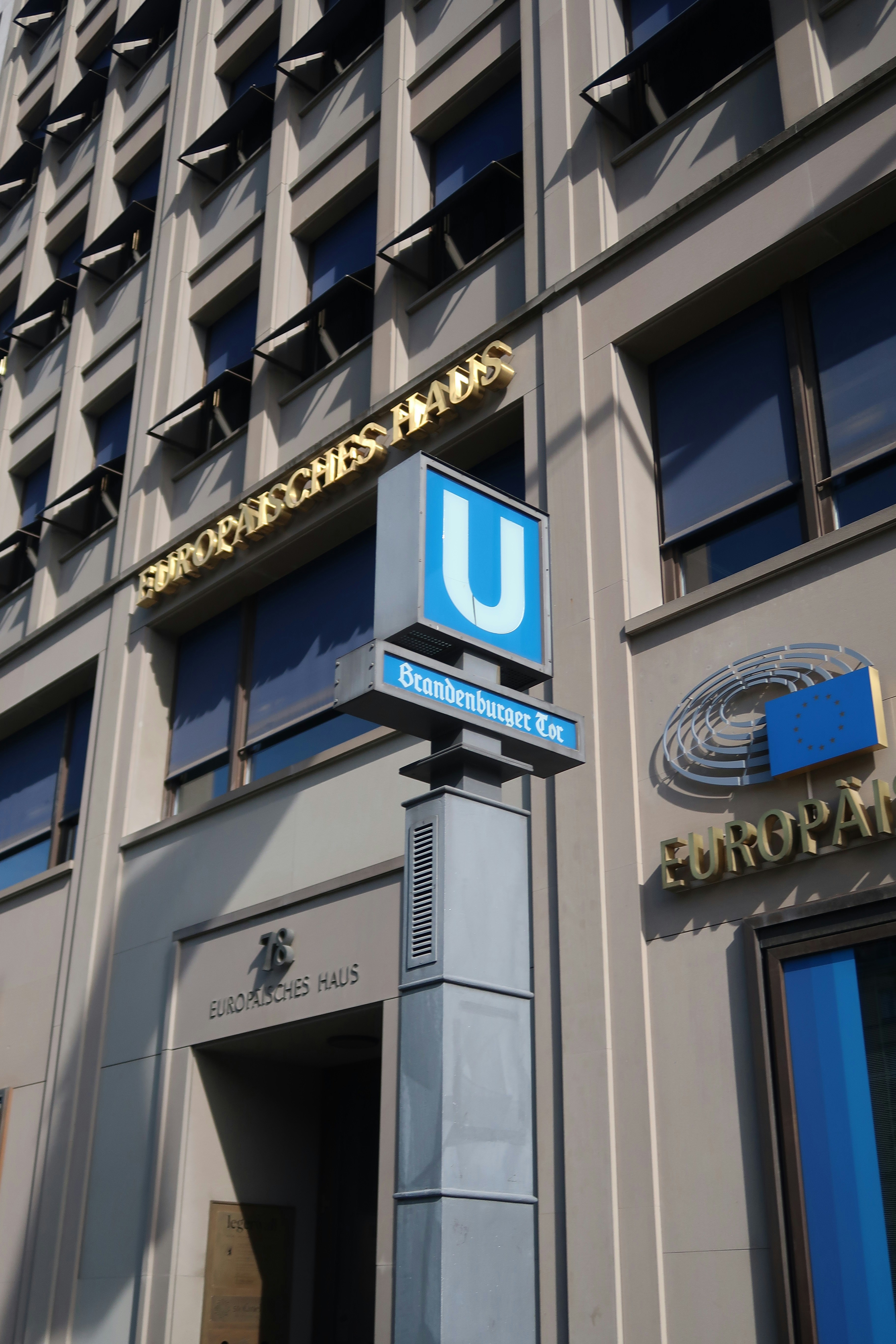A U-Bahn station sign for Brandenburger Tor in front of Europäisches Haus in Berlin
