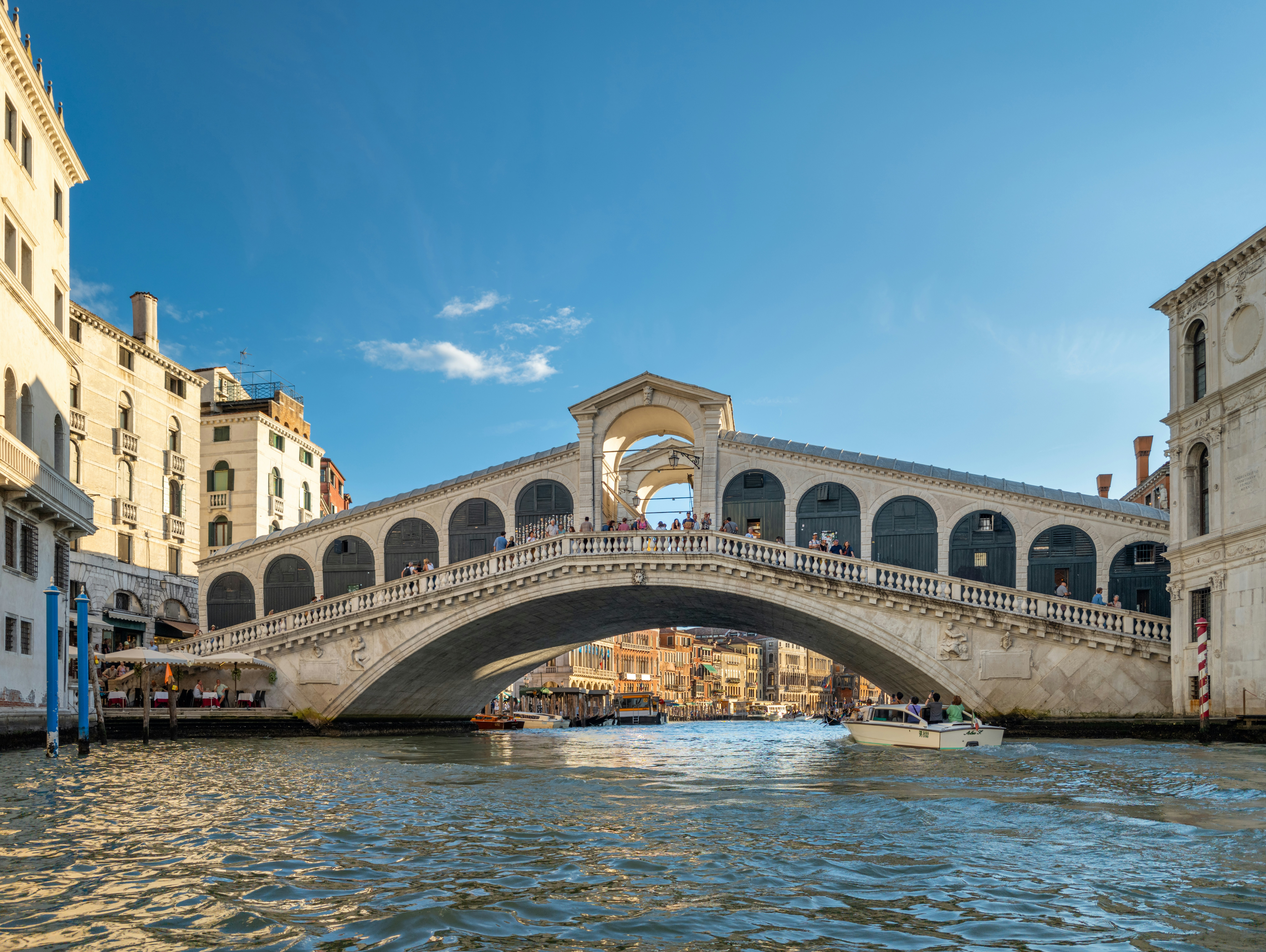 The Rialto Bridge spanning the Grand Canal in Venice with a boat passing underneath