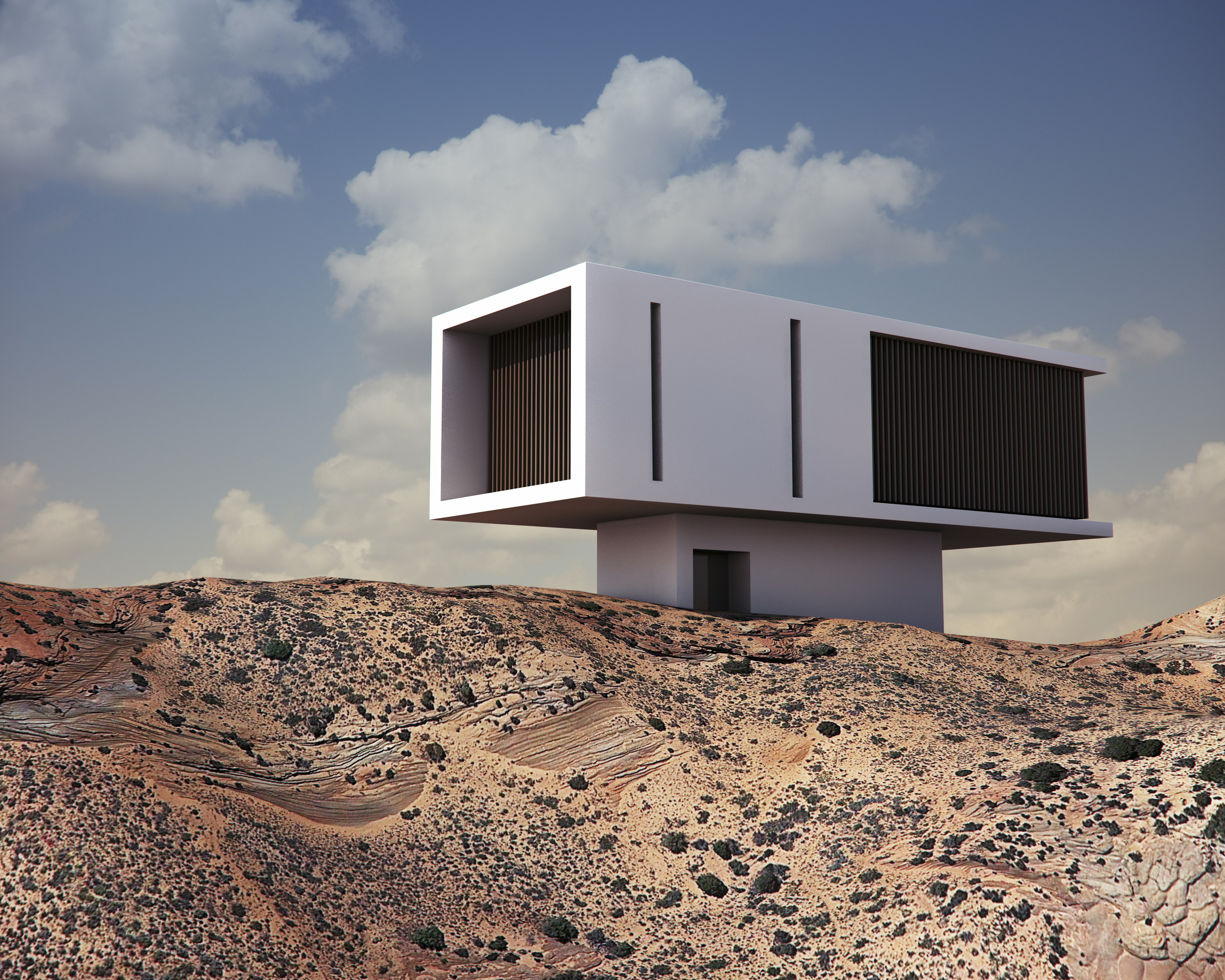 Una casa moderna blanca y rectangular en una colina rocosa bajo un cielo azul