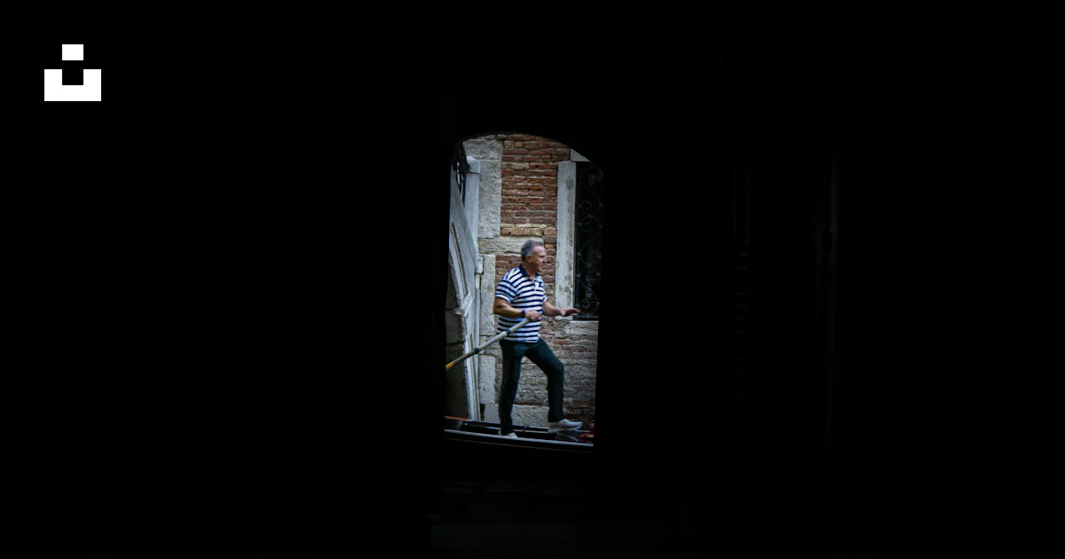Man Rowing Boat Phot Man rowing boat through stone archway - Free Photo on Unsplash