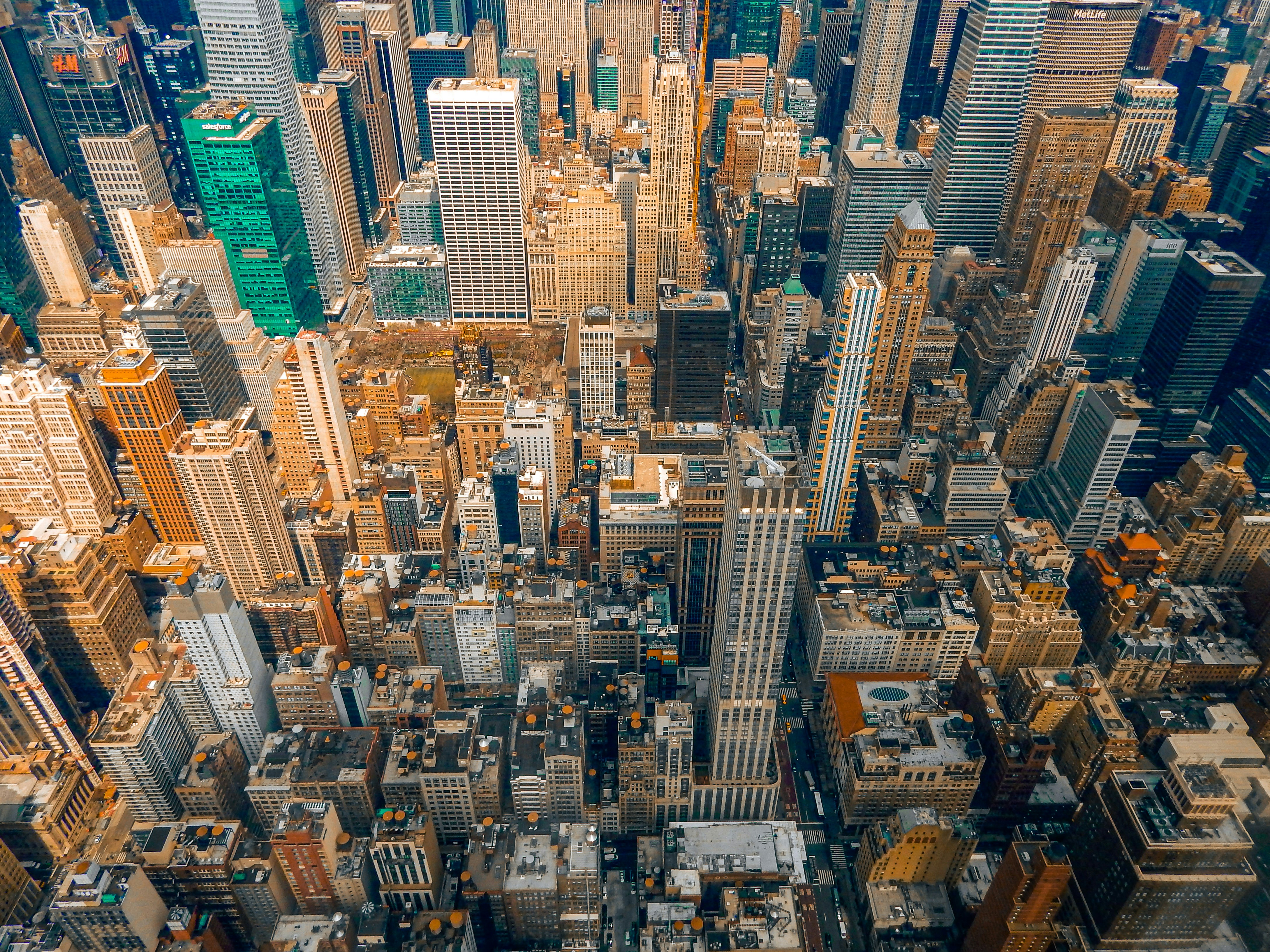 An aerial view of dense skyscrapers and city buildings in New York City