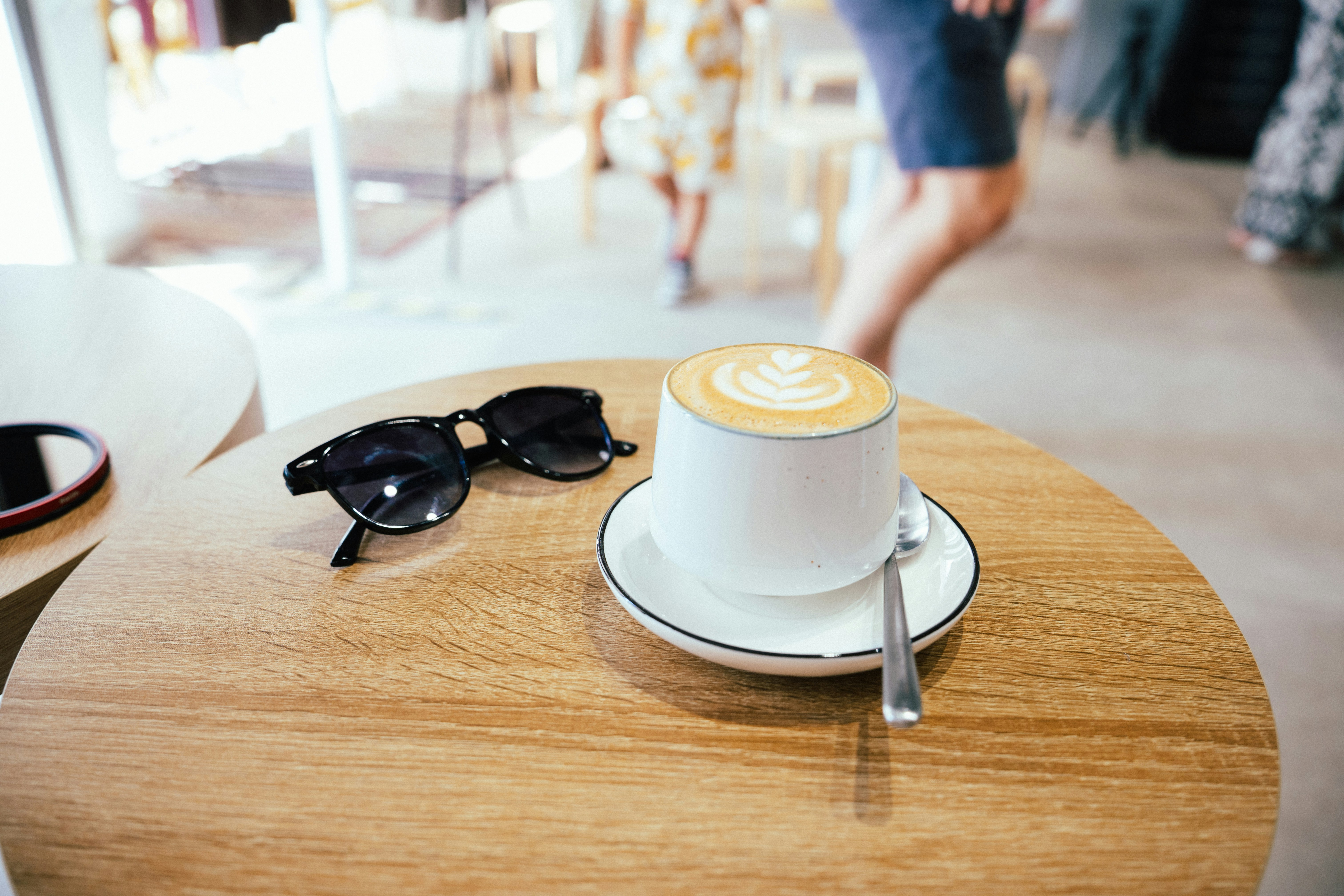 Latte on a round cafe table outdoors