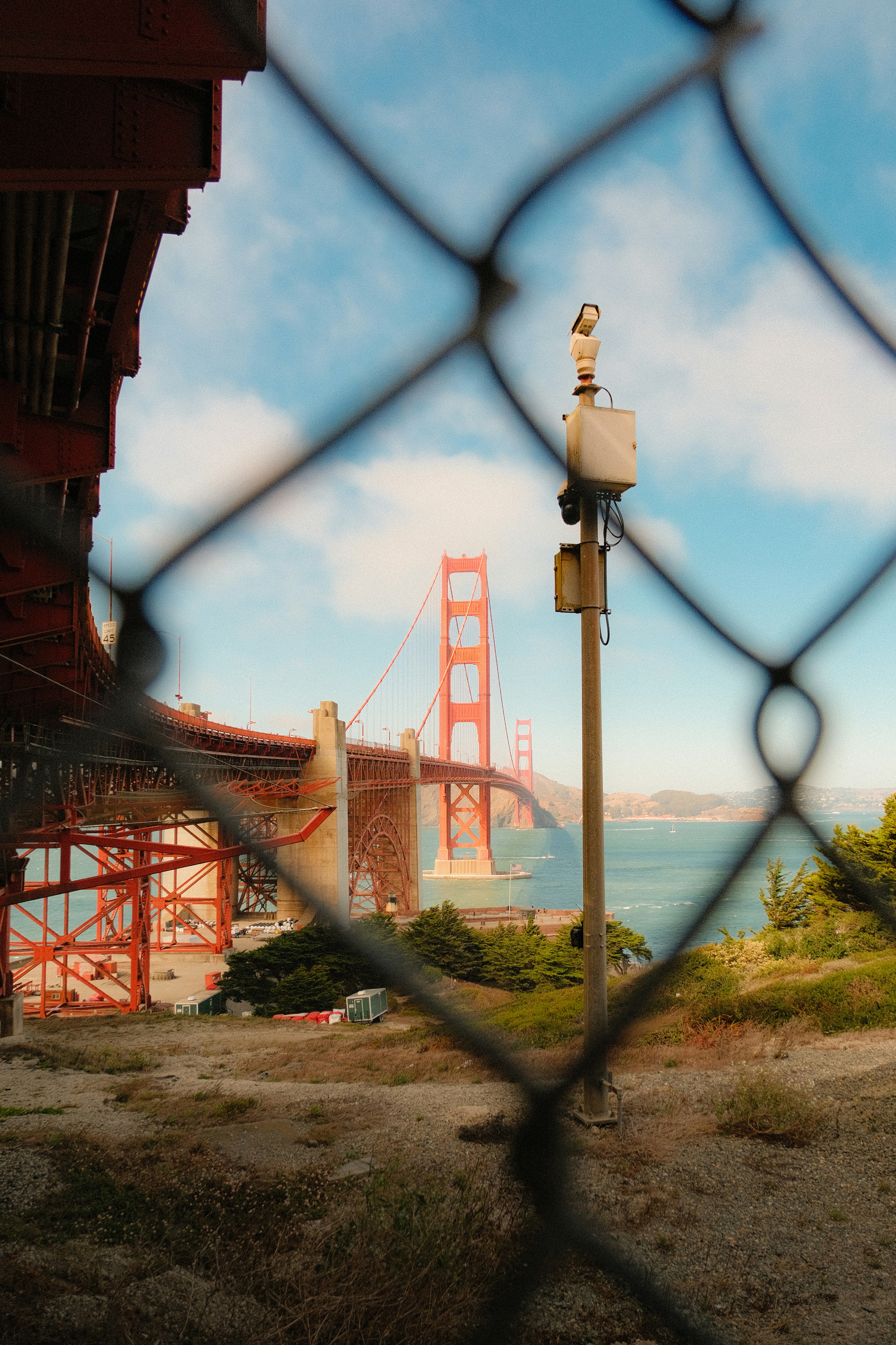 The Golden Gate Bridge in San Francisco viewed through a chain link fence