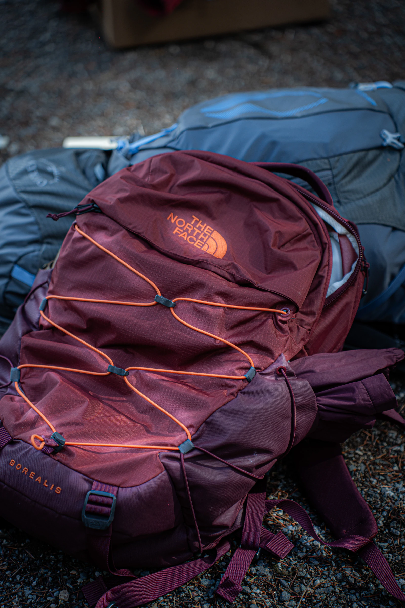 Maroon The North Face backpack with bungee cords