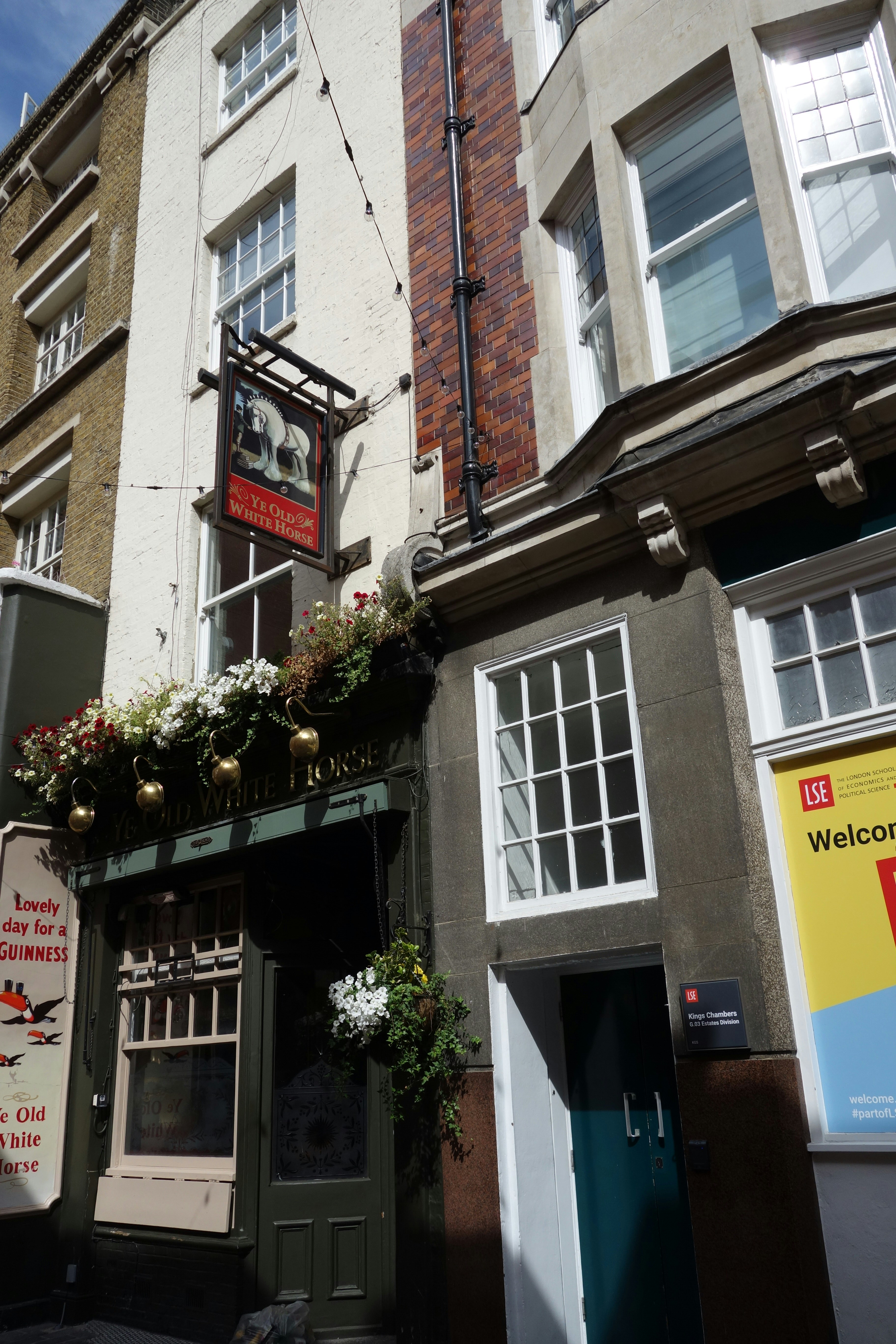 The Ye Olde White Horse pub exterior with hanging flower baskets in London