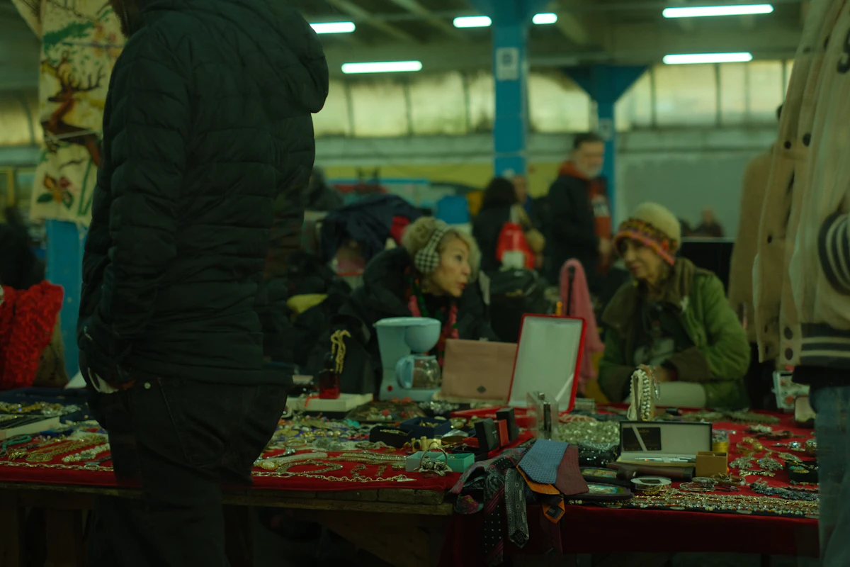 Shoppers browsing vintage jewelry at an indoor market