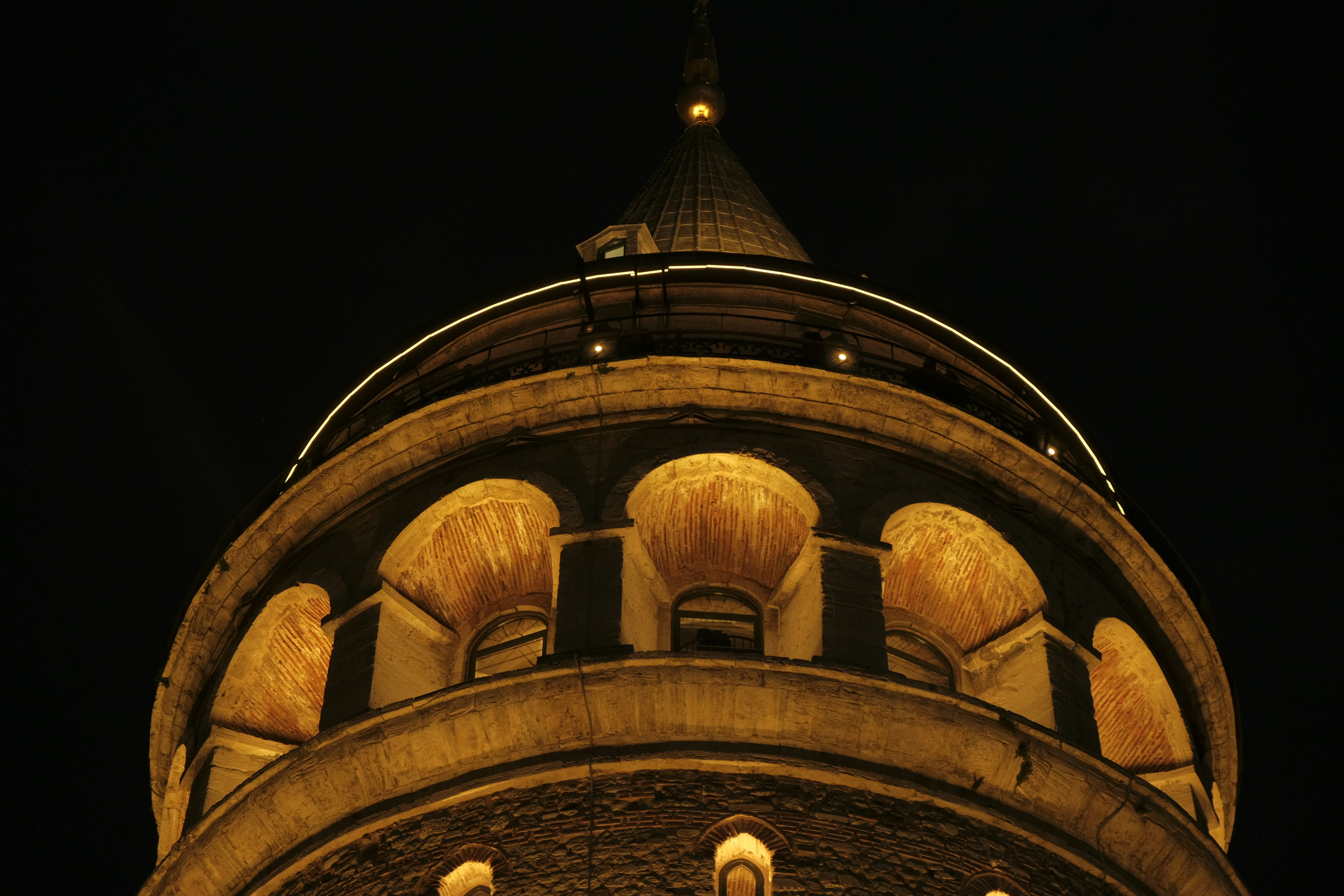 The illuminated stone arches of the Galata Tower in Istanbul at night