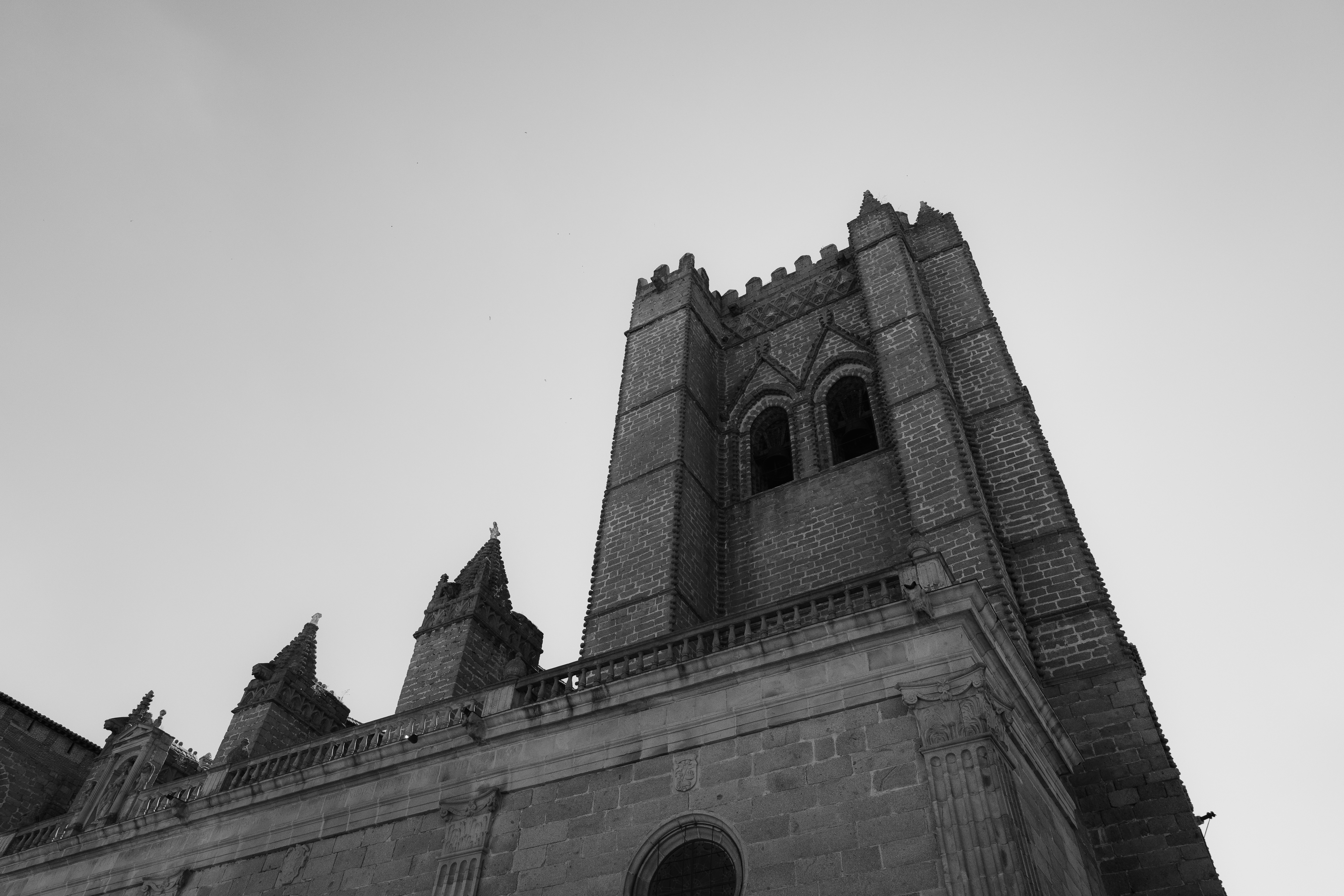 A low angle view of a stone cathedral tower with arched windows