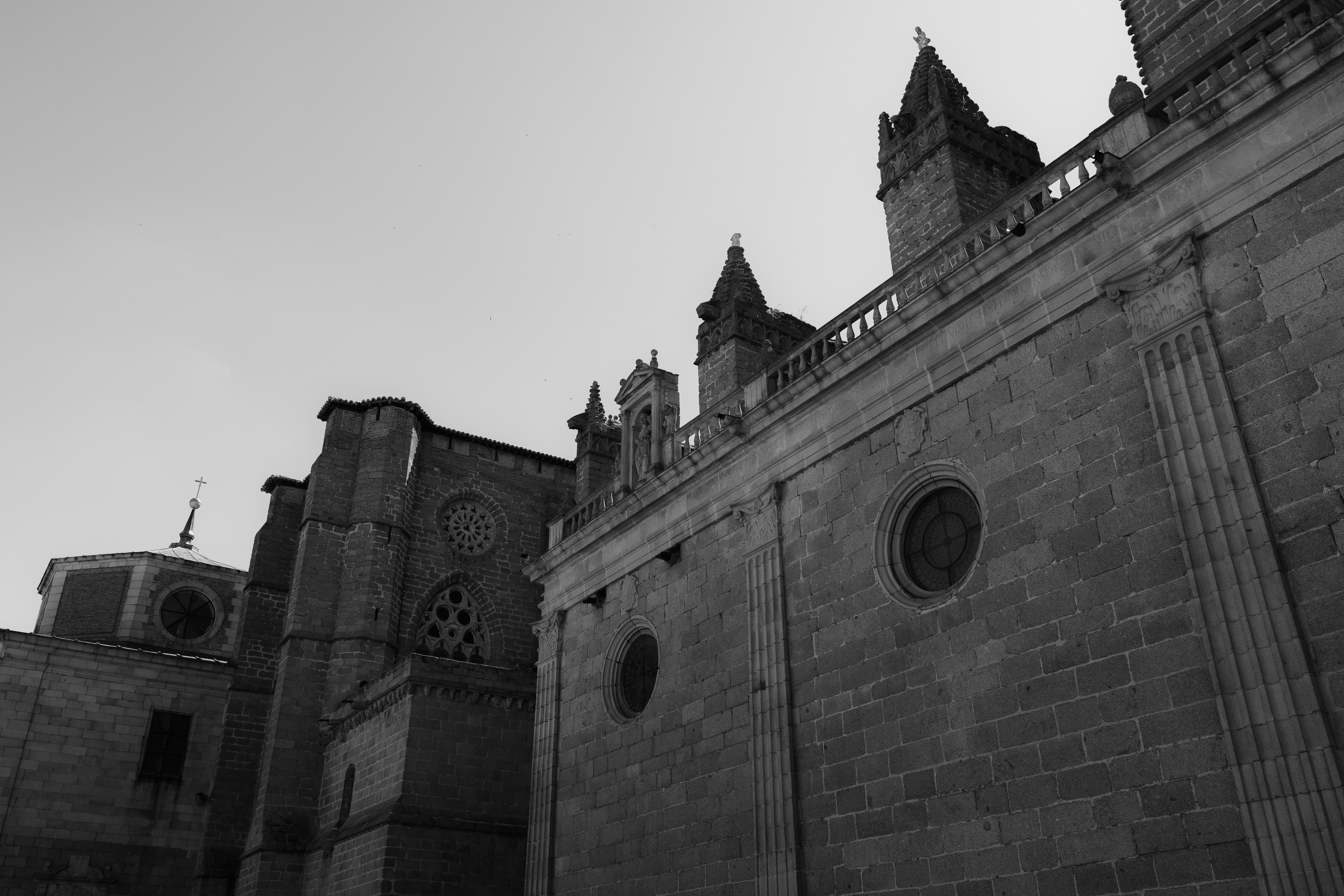 A black and white view of a stone cathedral with gothic architectural details