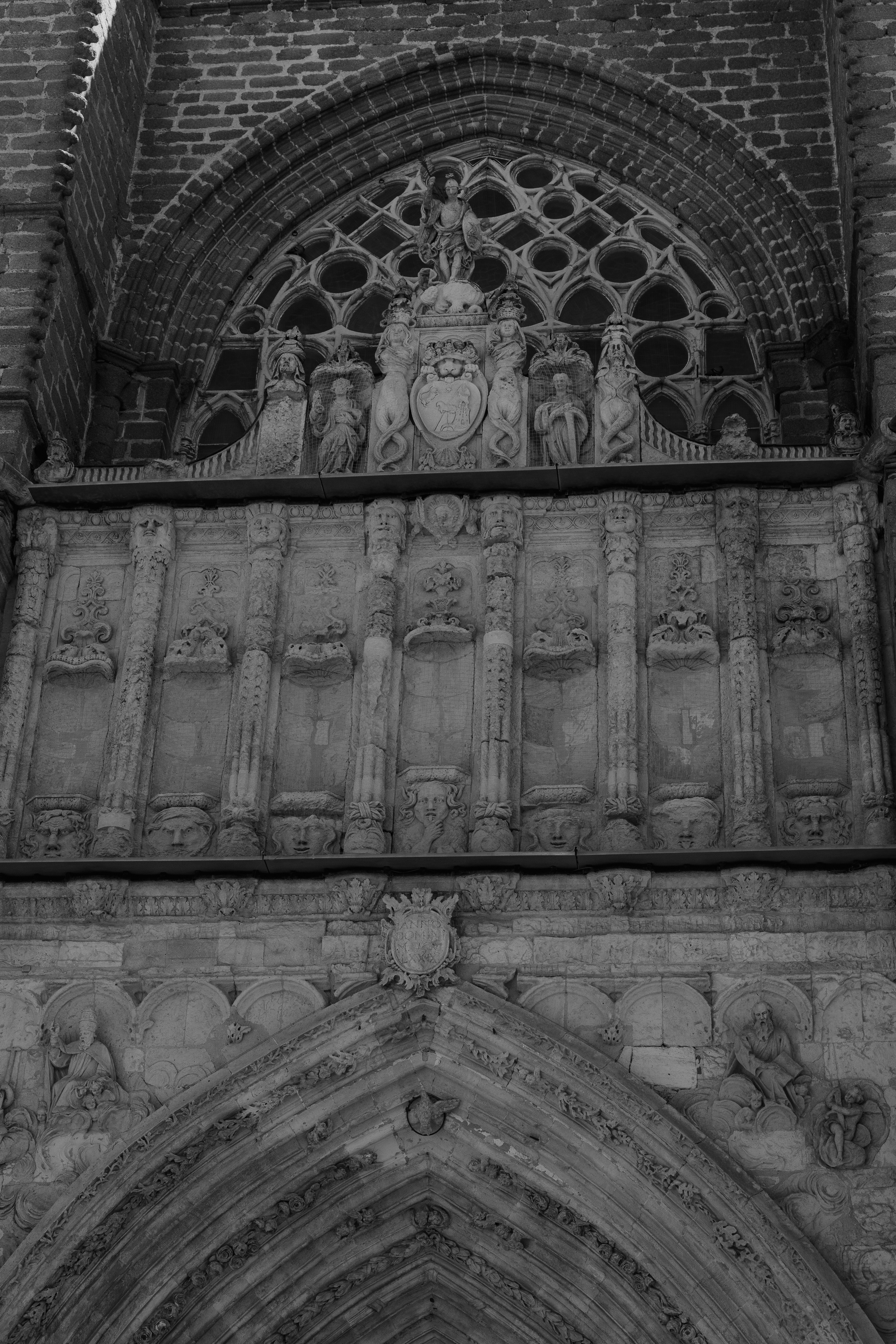 Intricate stone carvings and sculptures on the facade of a historic gothic cathedral