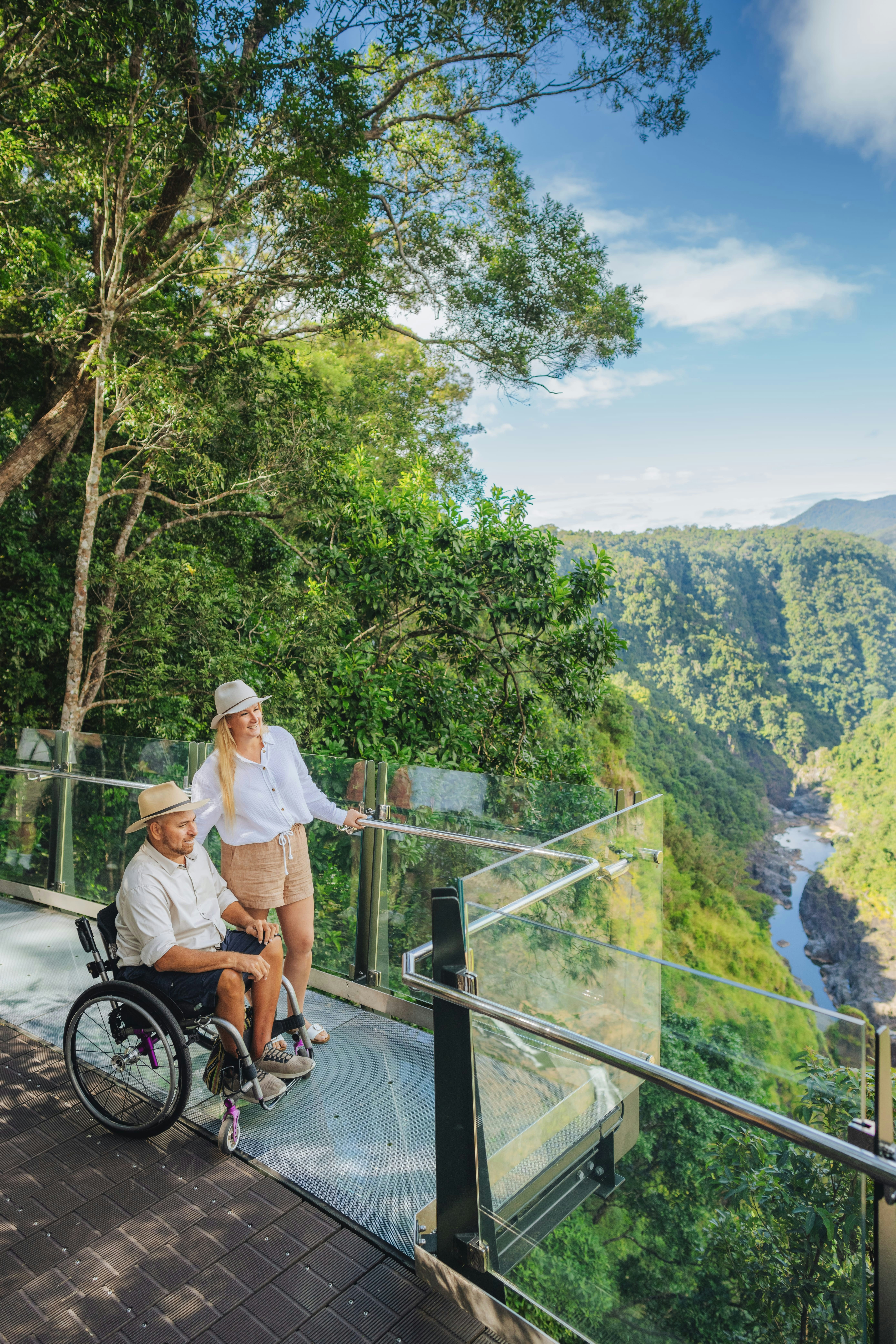 Couple high above the rainforest at The Edge Lookout. Location: Barron Falls, Skyrail Rainforest Cableway, Tropical North Queensland.