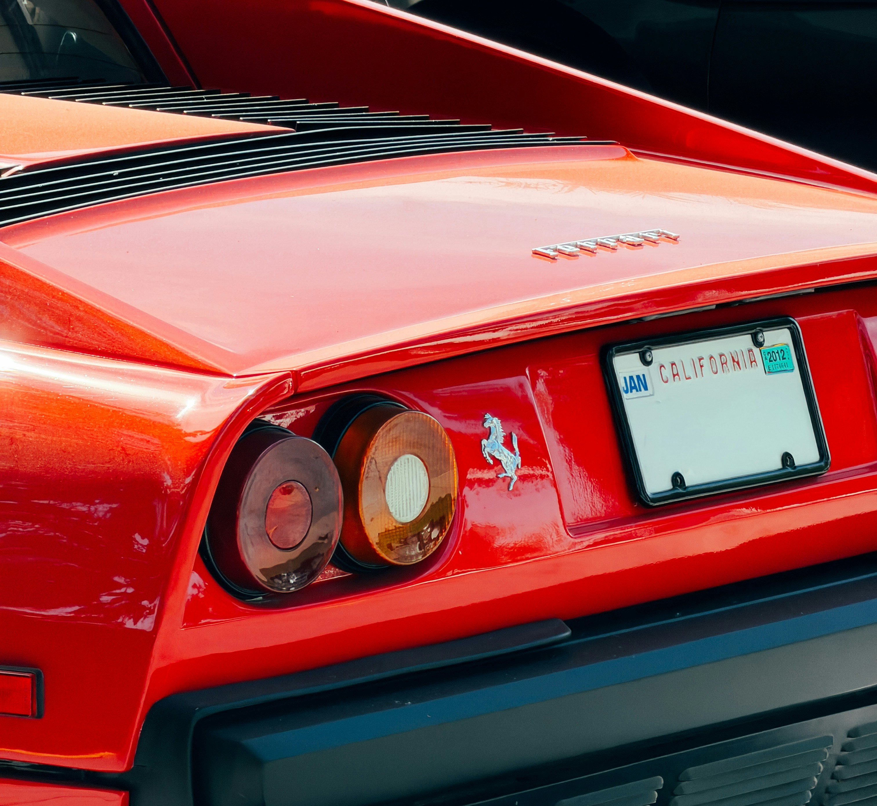 Rear view of a red sports car with a California license plate