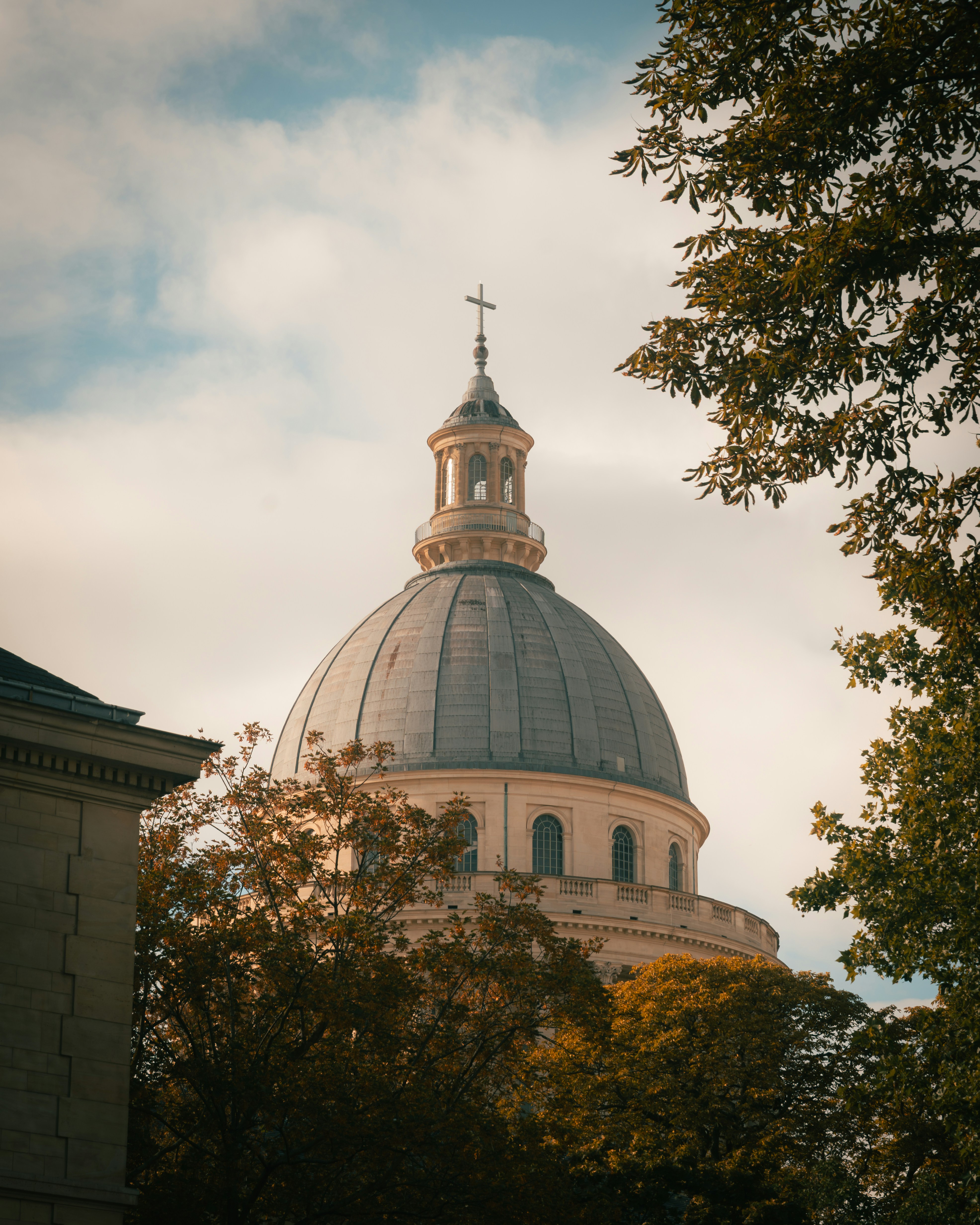 The dome of the Pantheon in Paris rising above autumn trees
