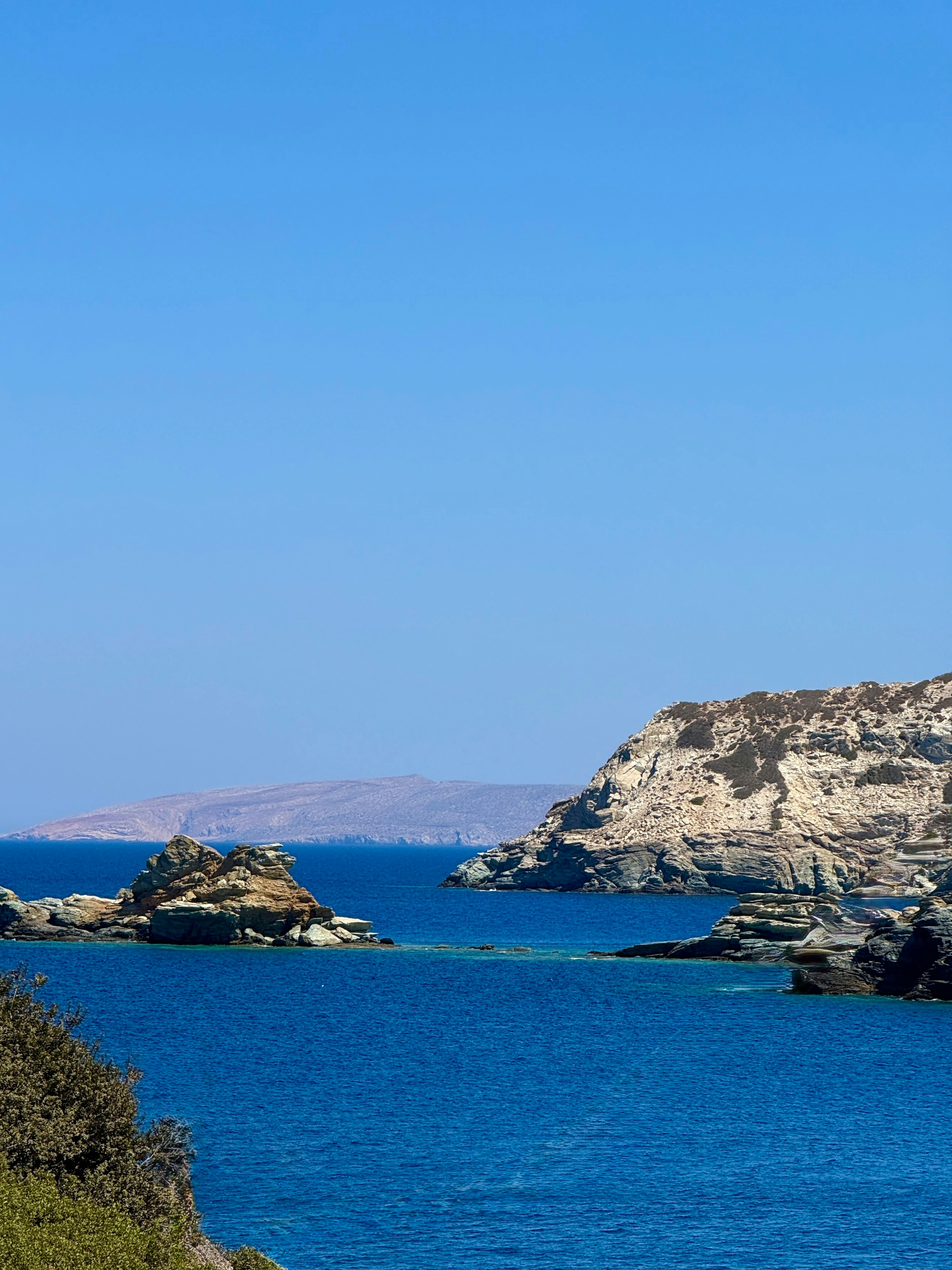 Rocky islands in deep blue water under a clear sky
