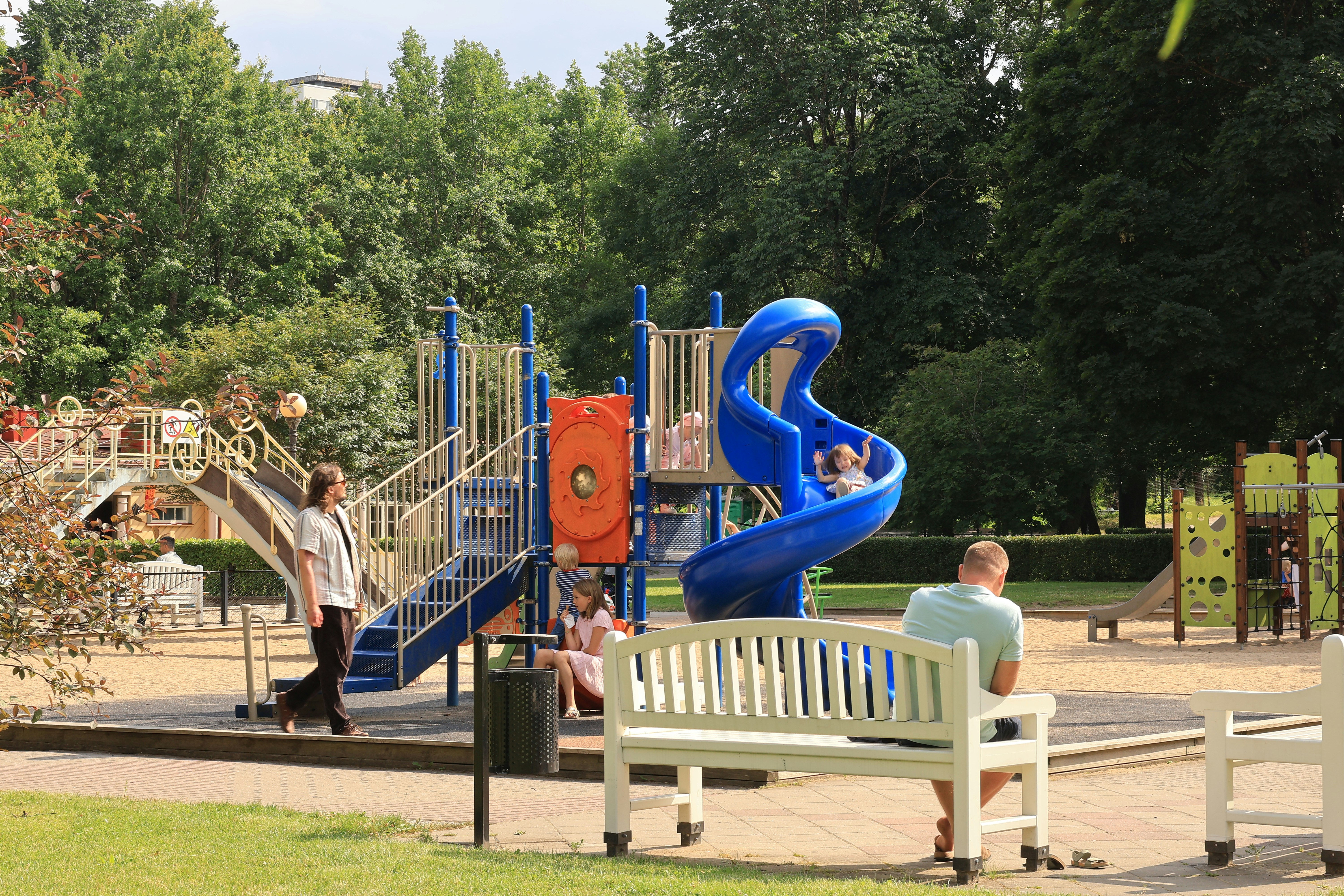 Playground with a blue slide and benches