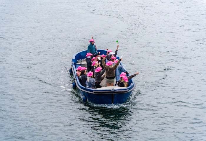 Group in pink hats on a boat