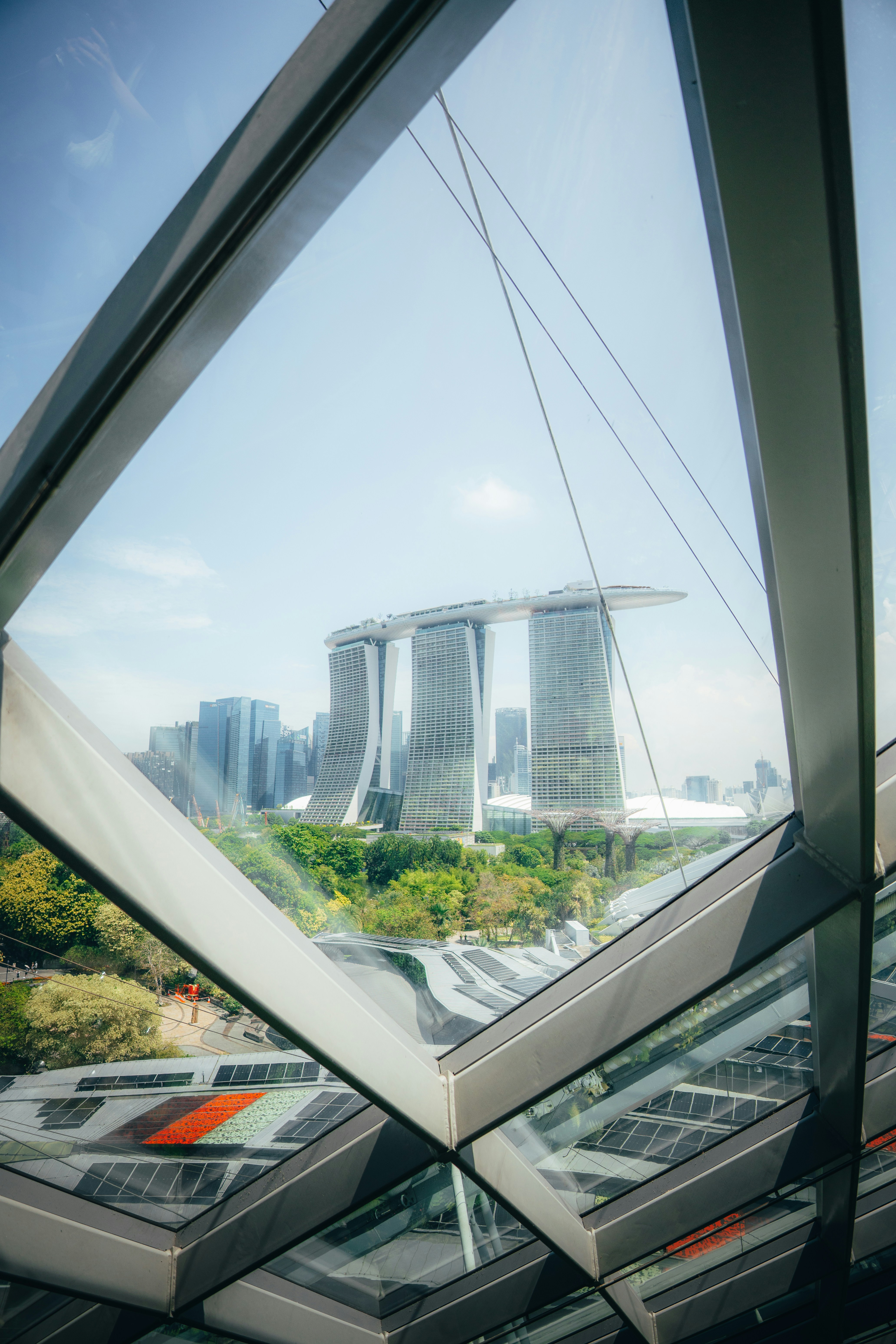 Marina Bay Sands hotel viewed through a triangular glass window frame in Singapore