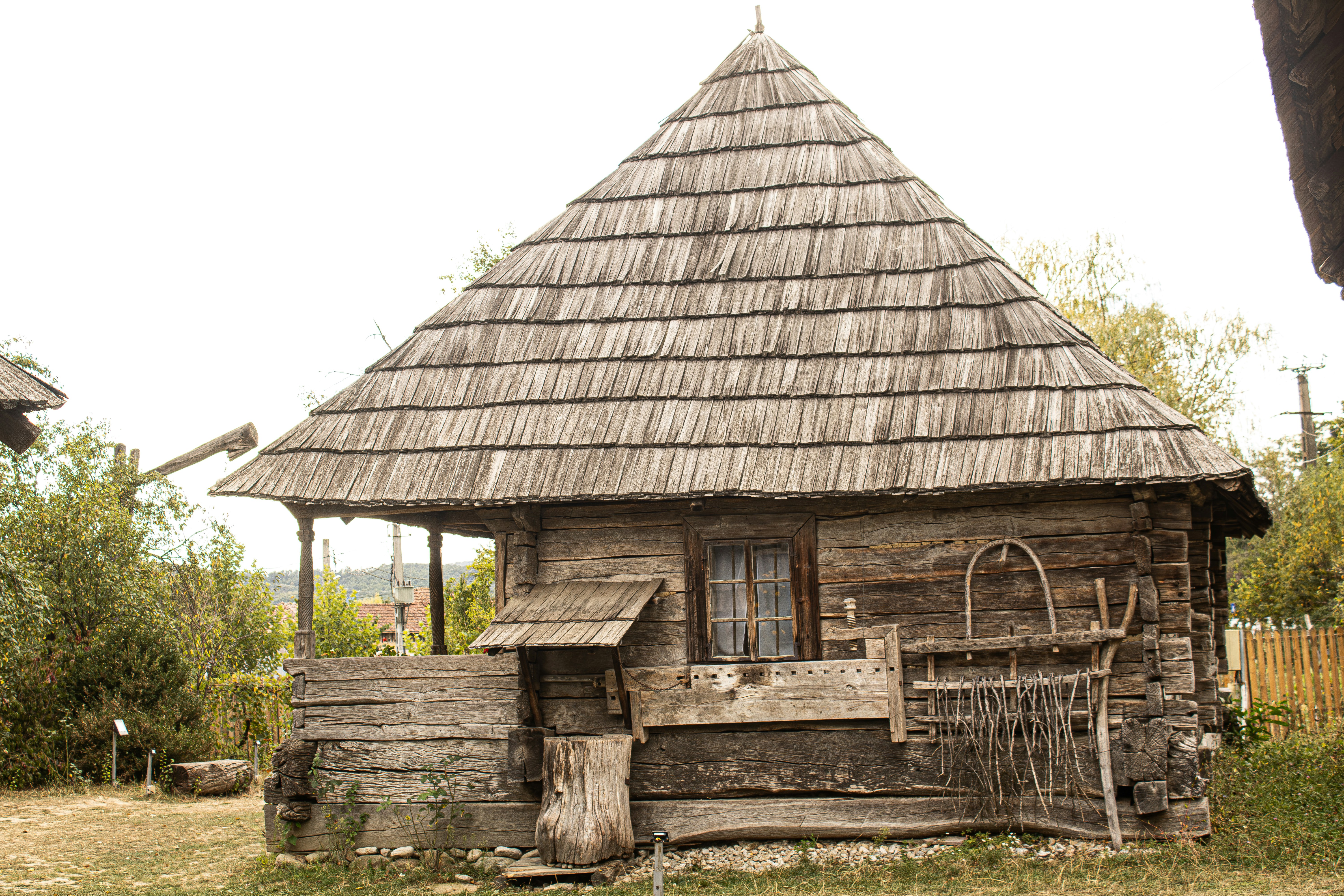 A rustic wooden cabin with a steep shingled roof and a small porch
