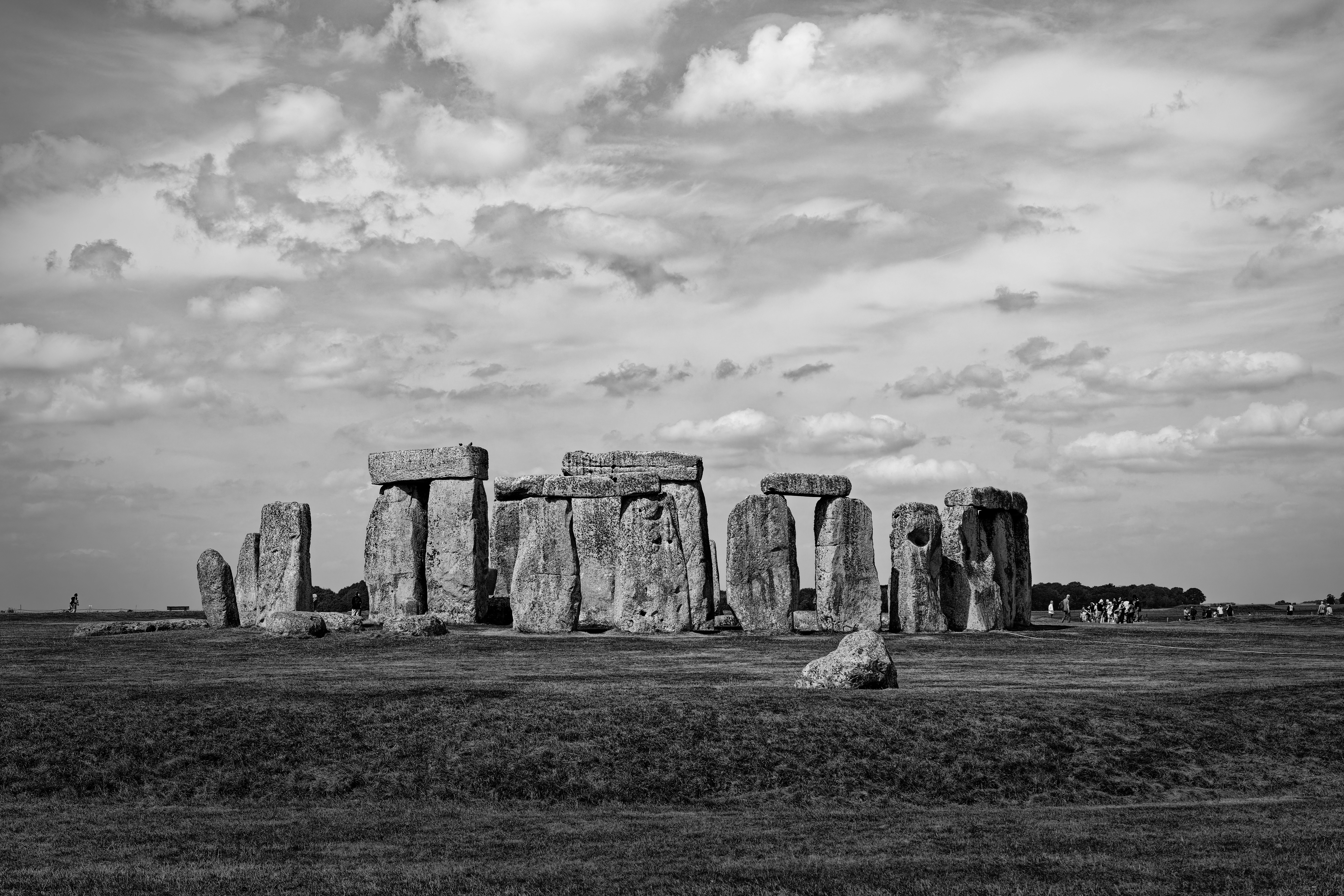 Stonehenge megalithic monument in a grassy field under a cloudy sky