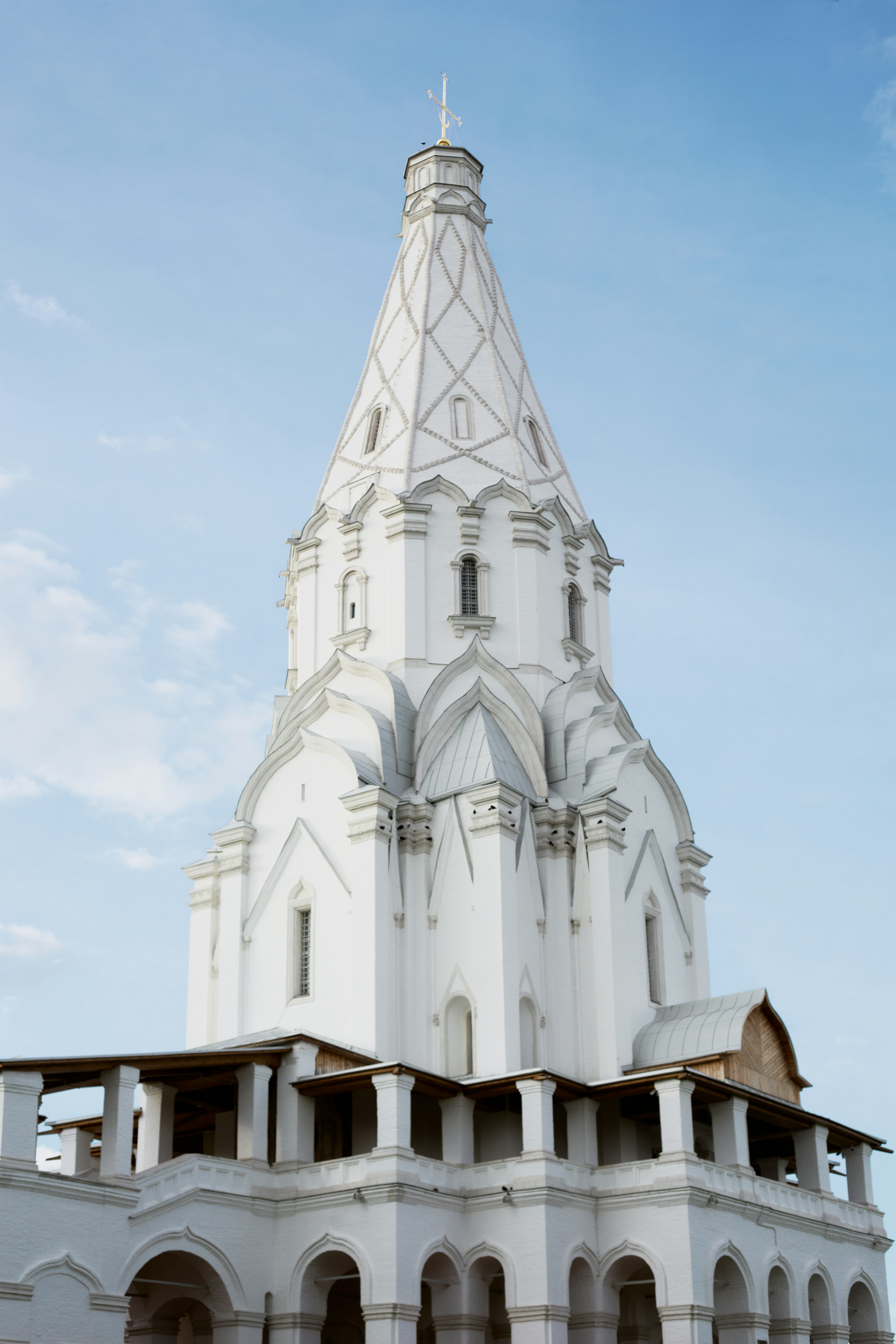 The white stone Church of the Ascension in Kolomenskoye, Moscow, against a blue sky