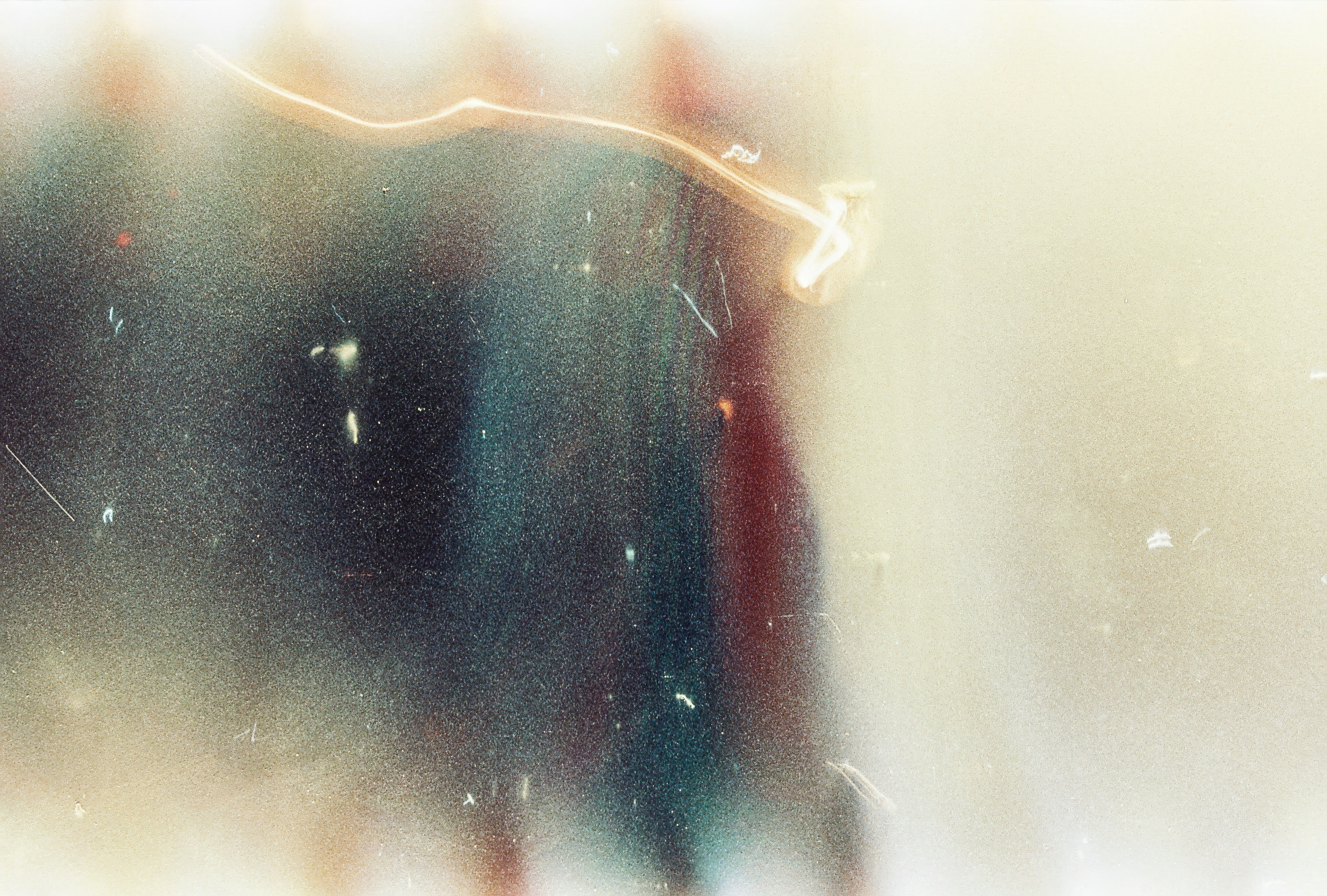 Abstract light streaks and film grain texture on a faded beige background