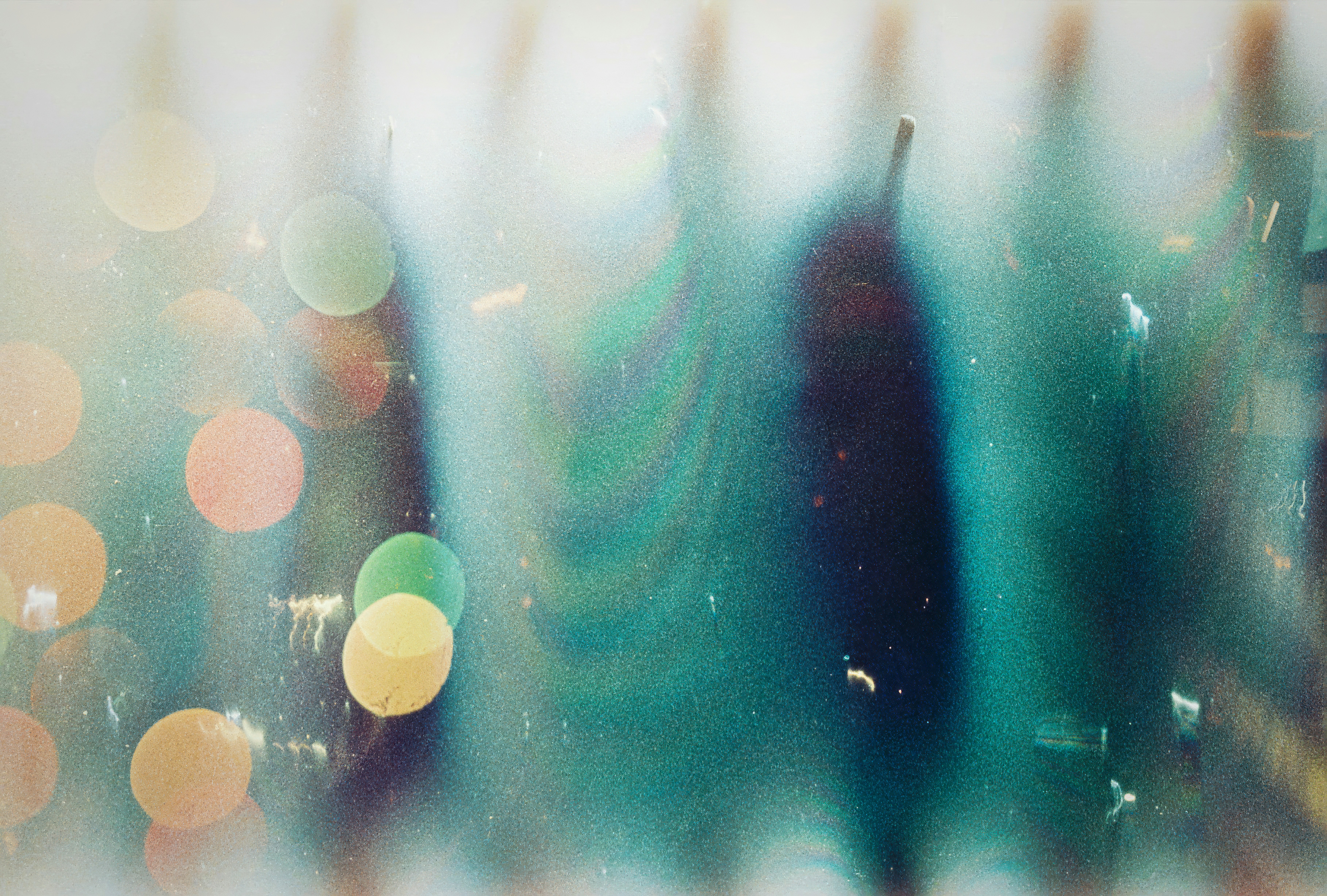 Abstract teal texture with soft bokeh light circles and vertical light streaks
