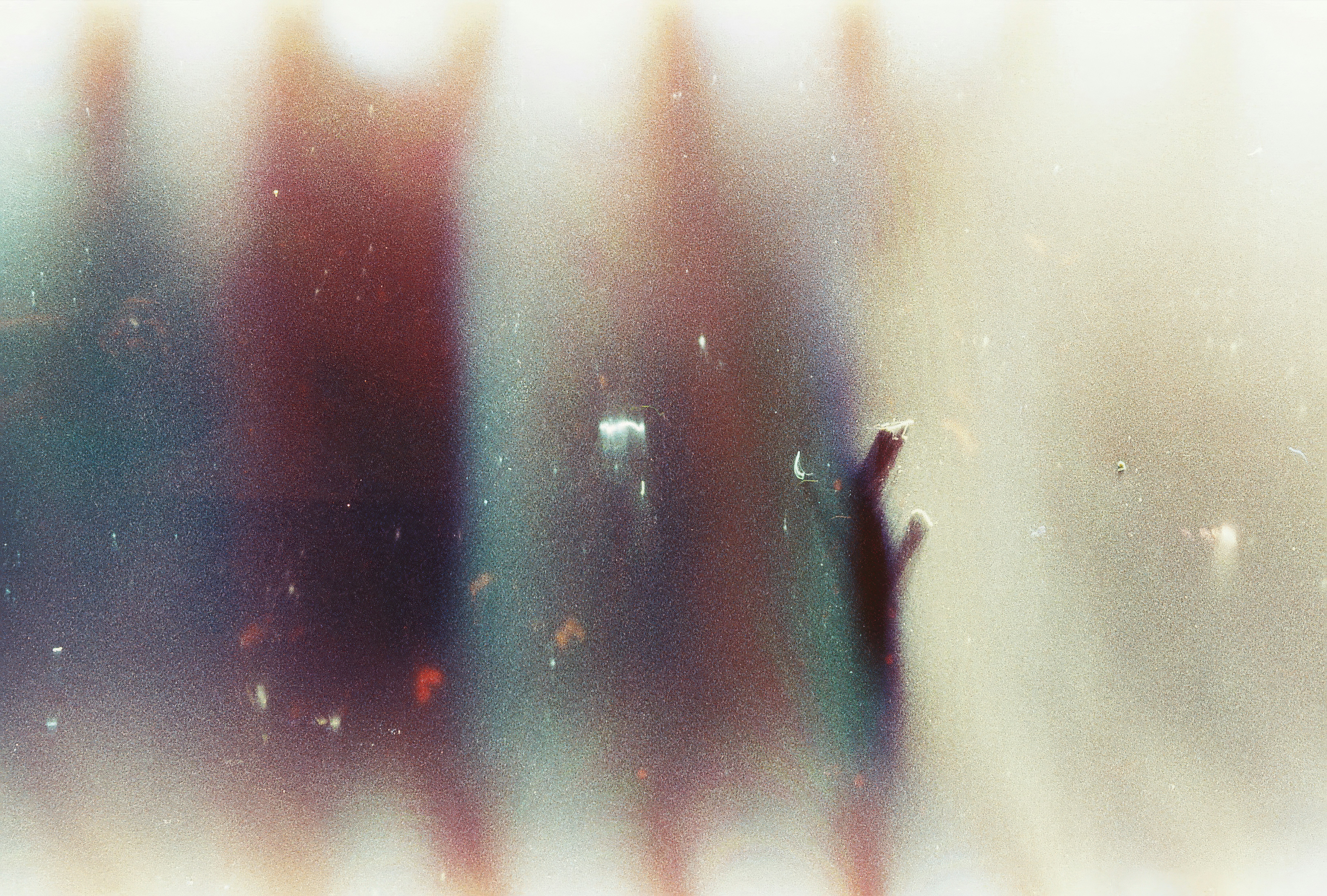 Abstract light leaks with vertical streaks of blue and orange on a grainy texture