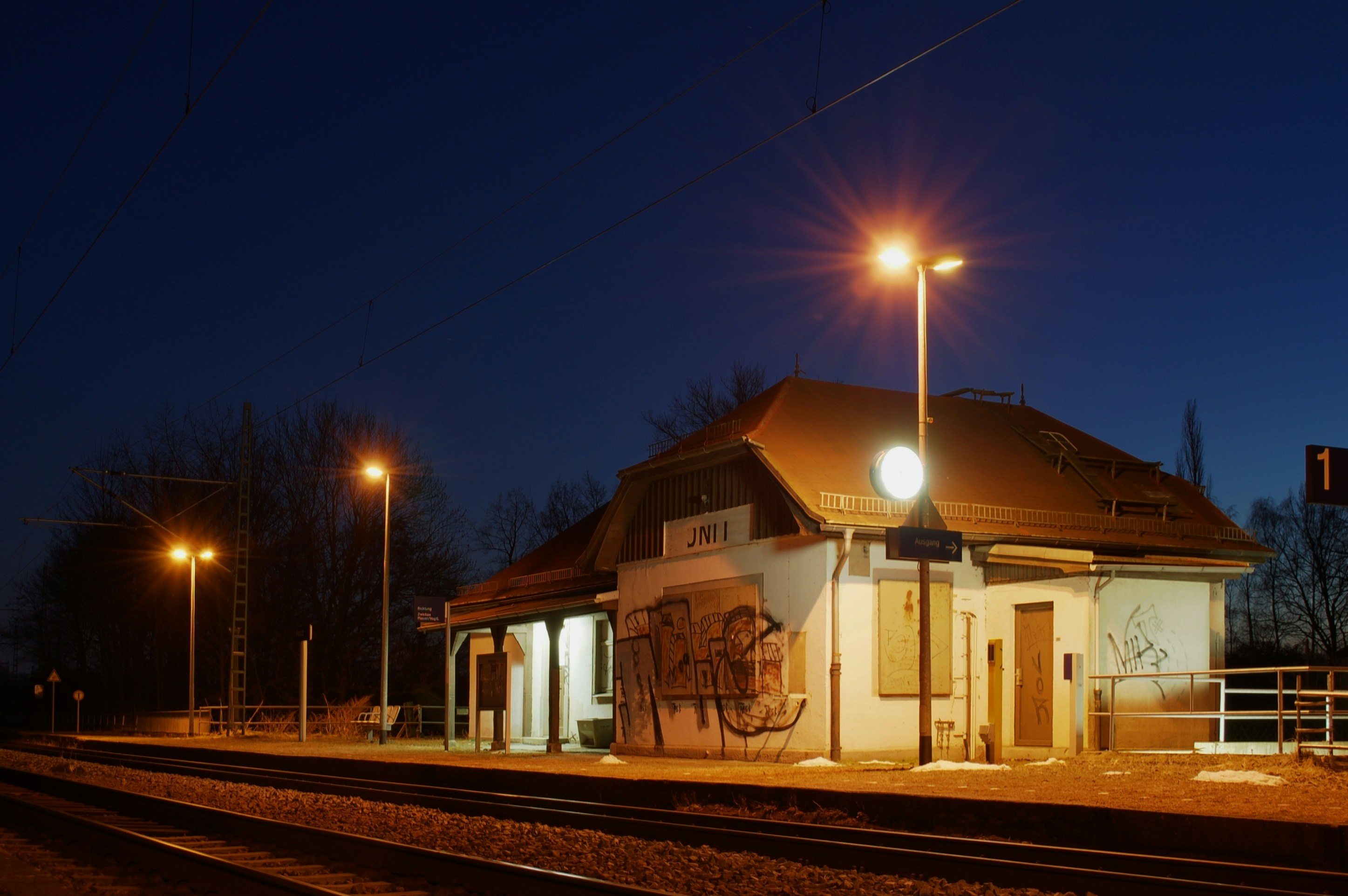 Small train station building lit at night