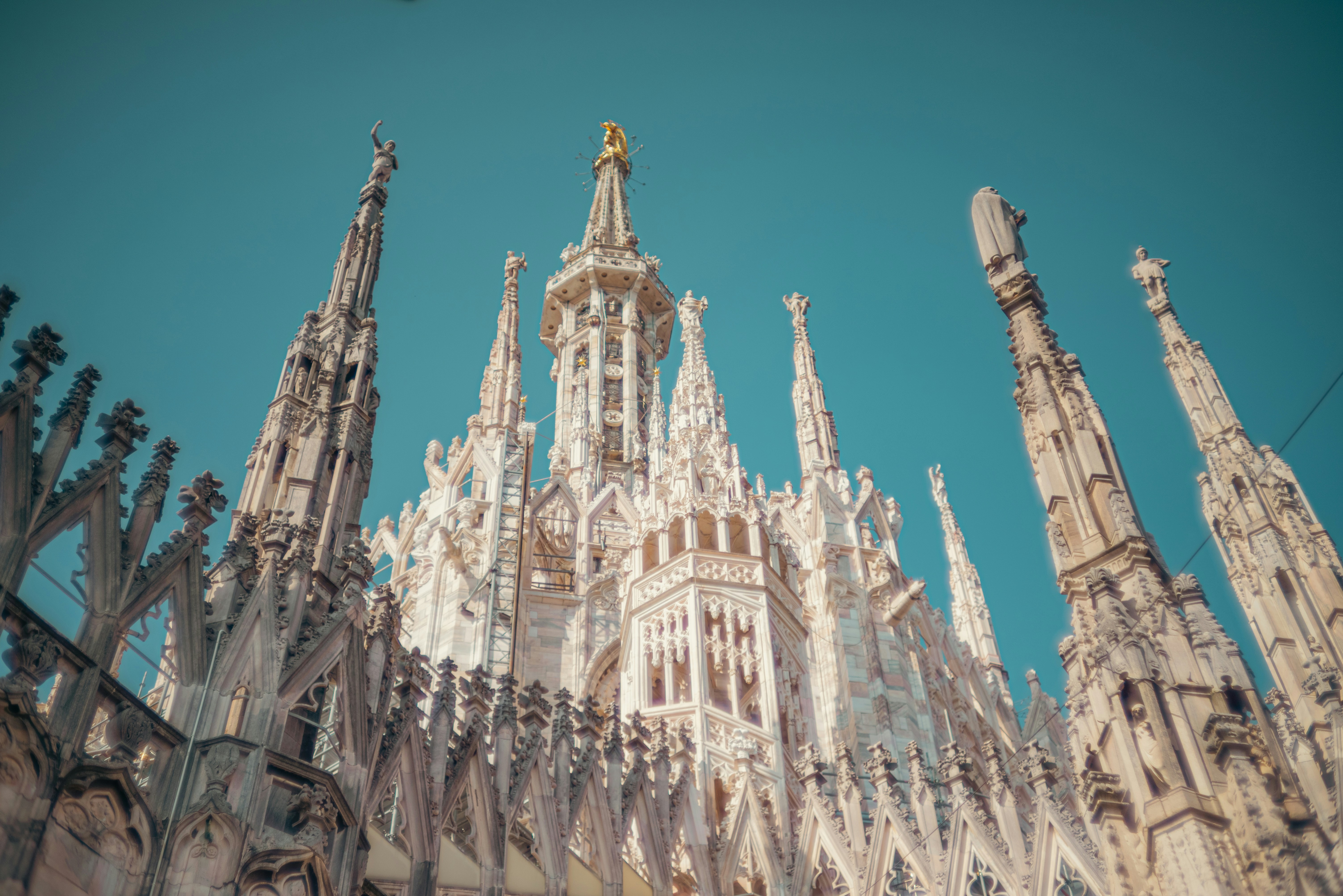 The intricate spires and marble architecture of the Duomo di Milano in Milan