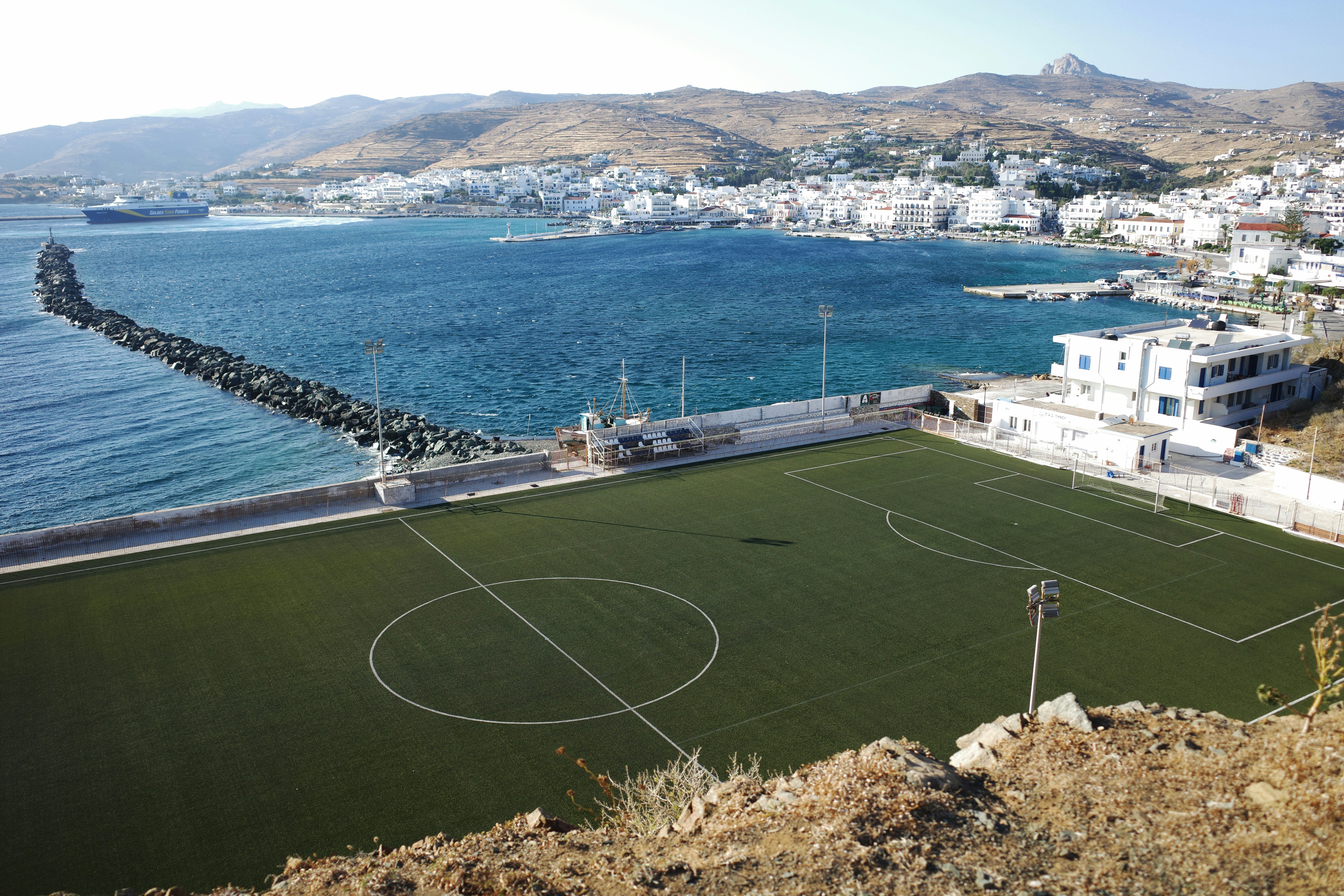 A soccer field on a harbor breakwater in Tinos, Greece