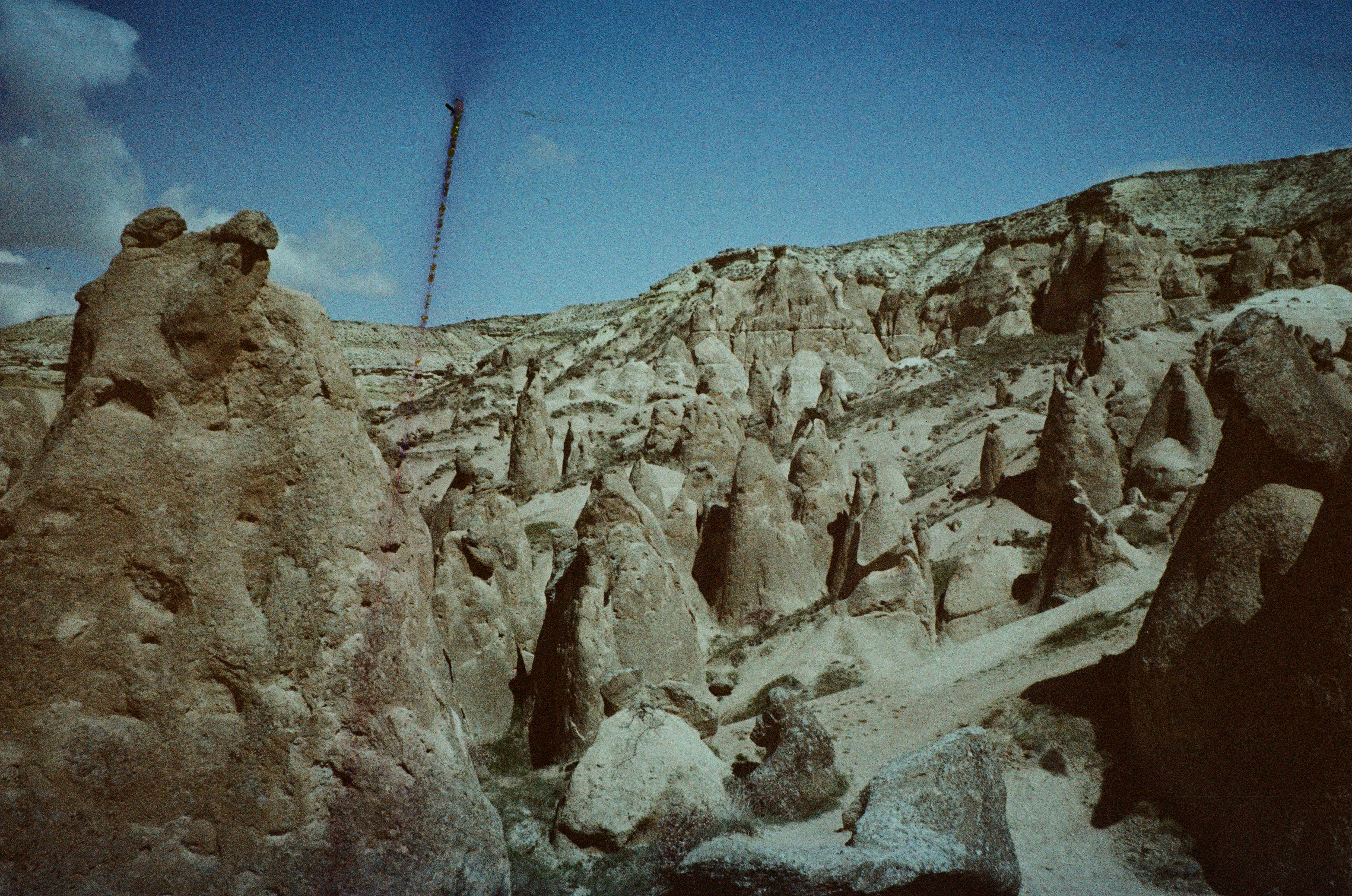 Eroded rock formations and fairy chimneys in the arid landscape of Cappadocia