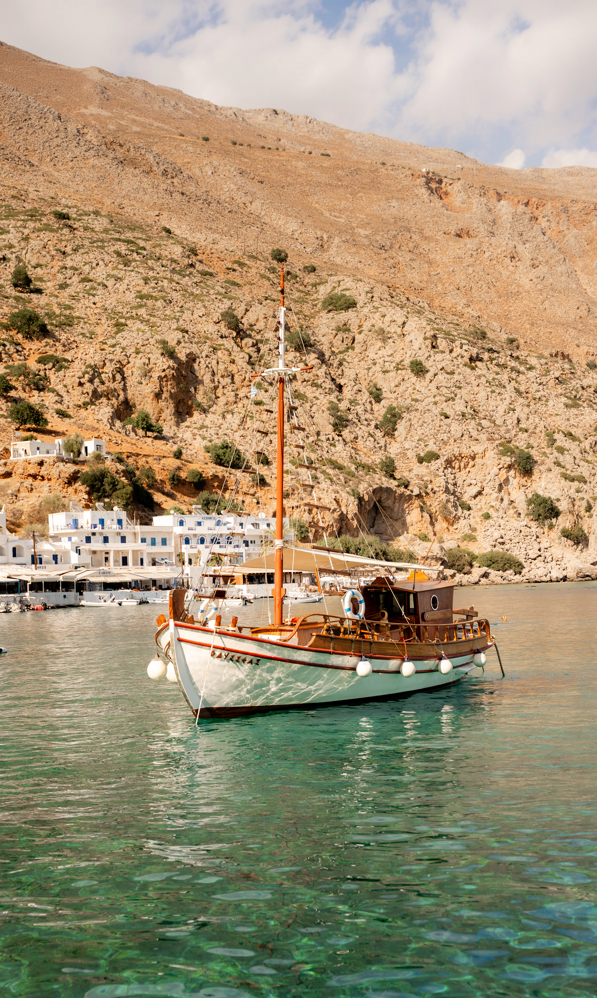 A traditional wooden boat anchored in a bay