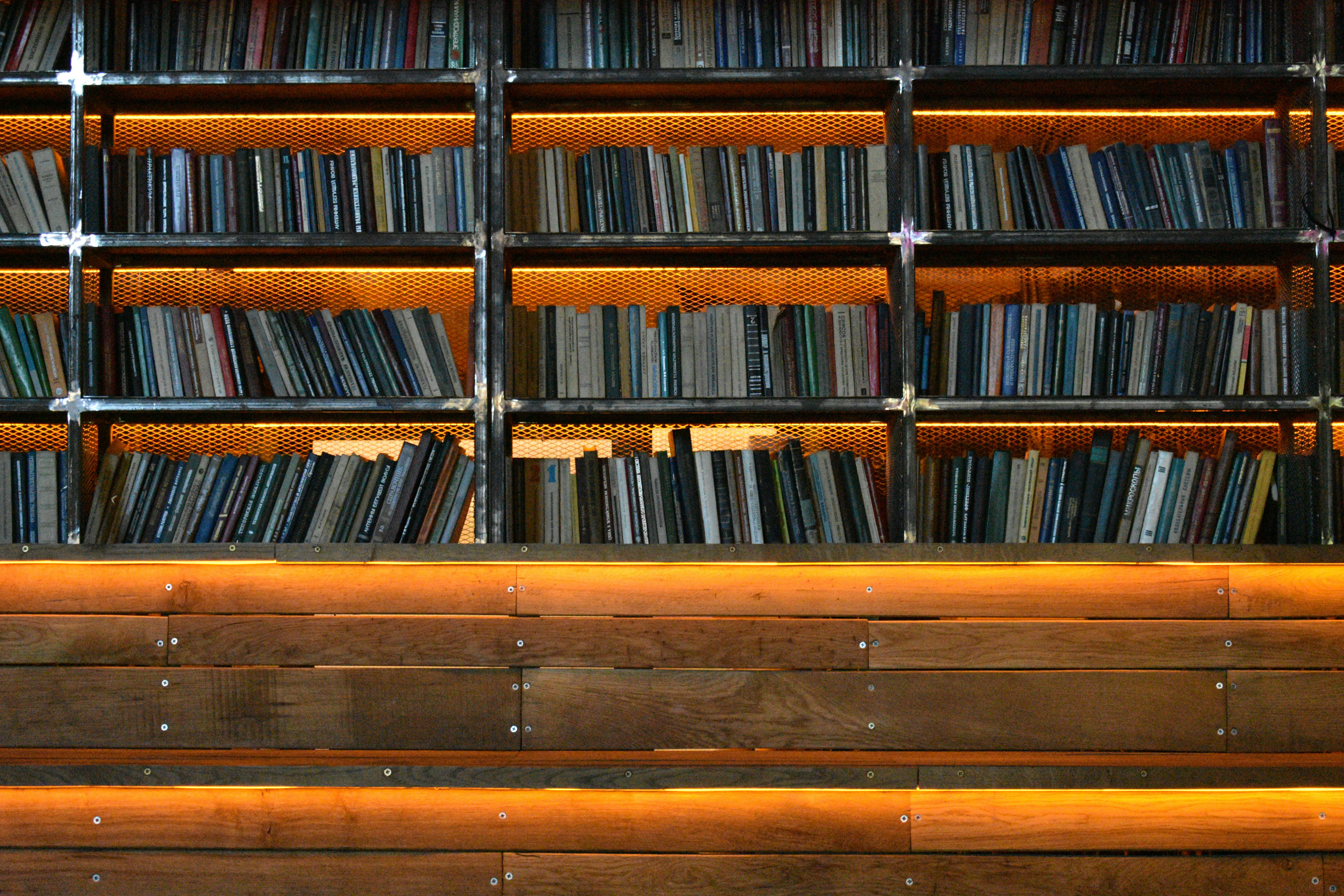 Books on shelves with warm orange backlight