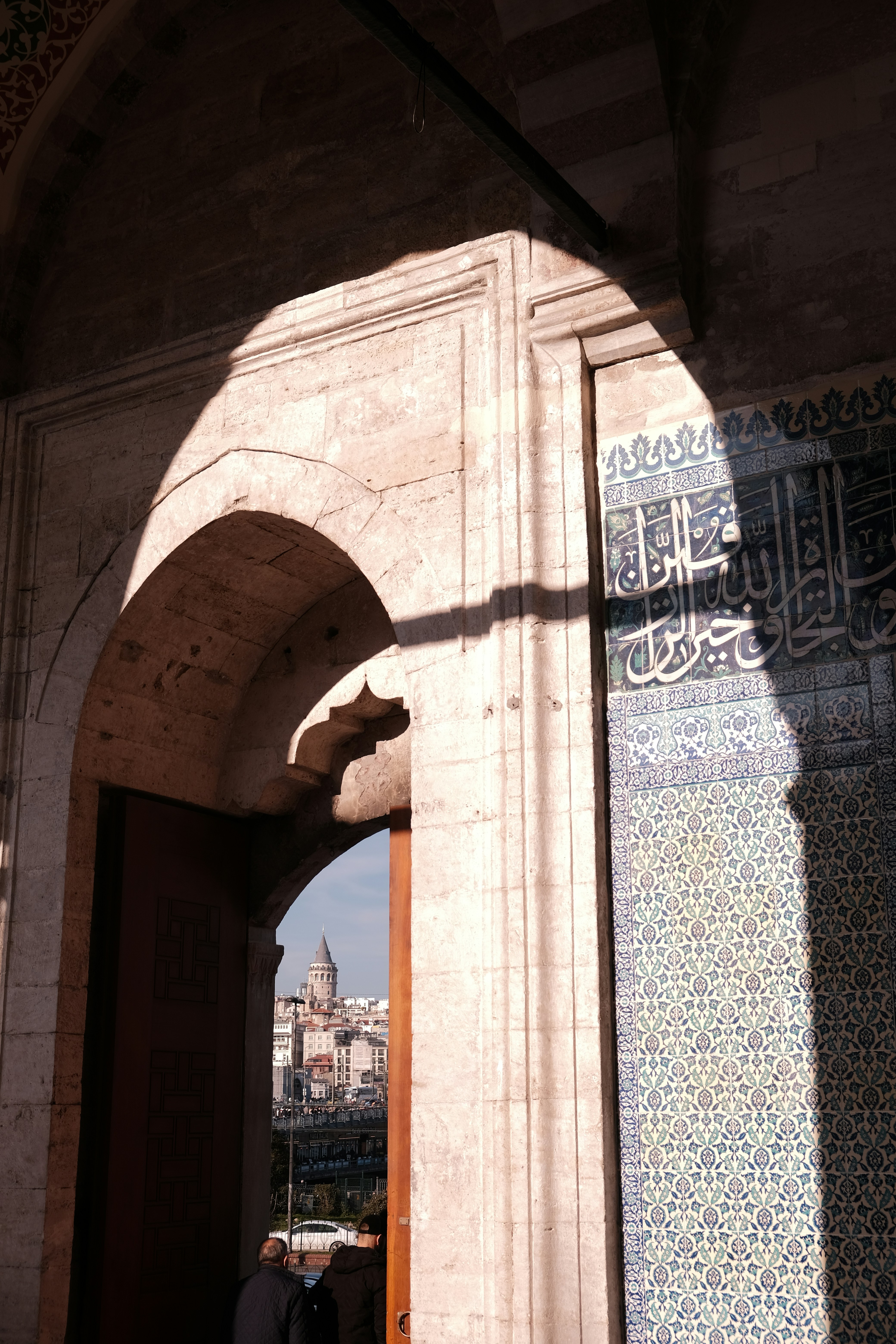 A stone archway framing a view of the Galata Tower in Istanbul