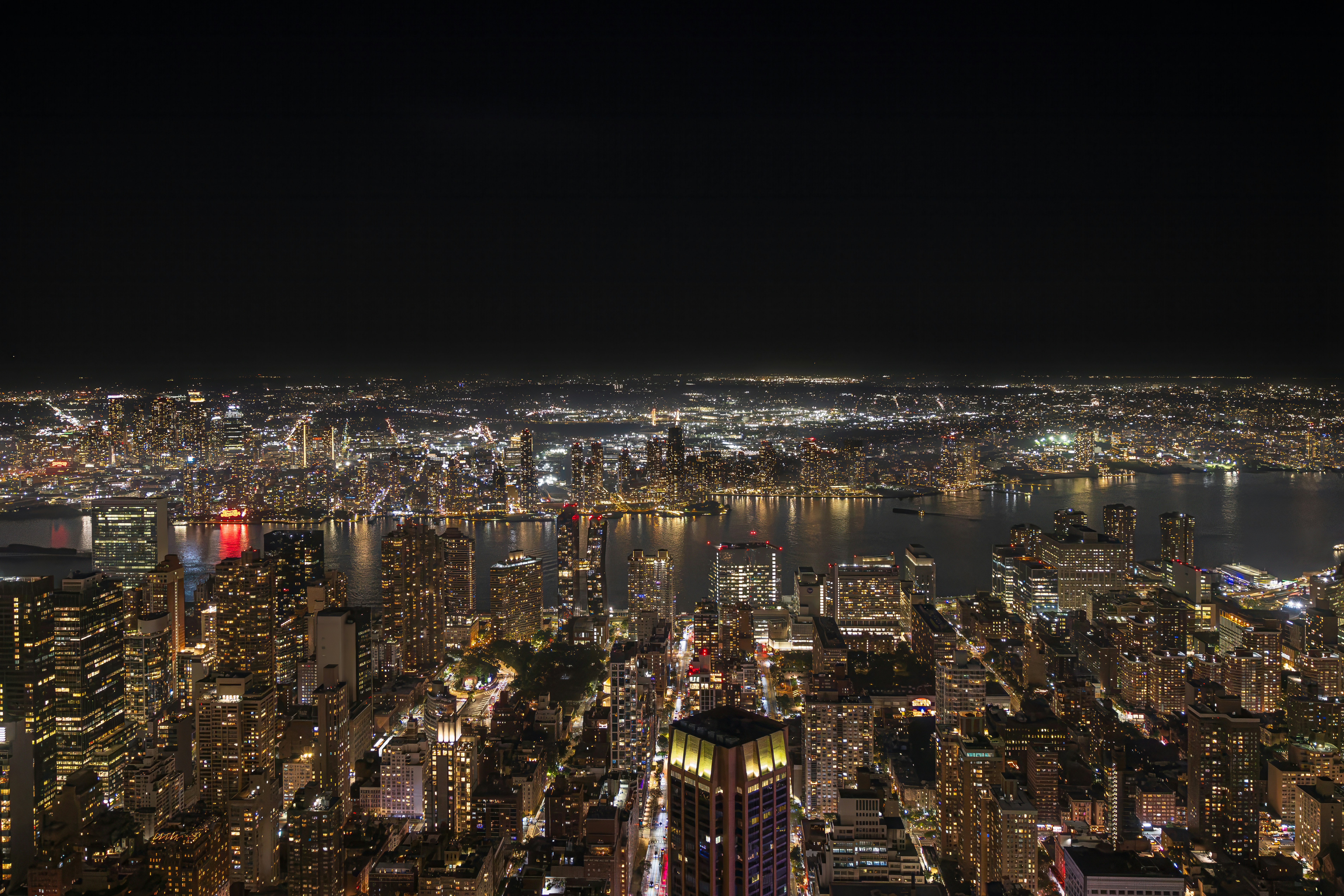 An aerial view of the illuminated New York City skyline at night