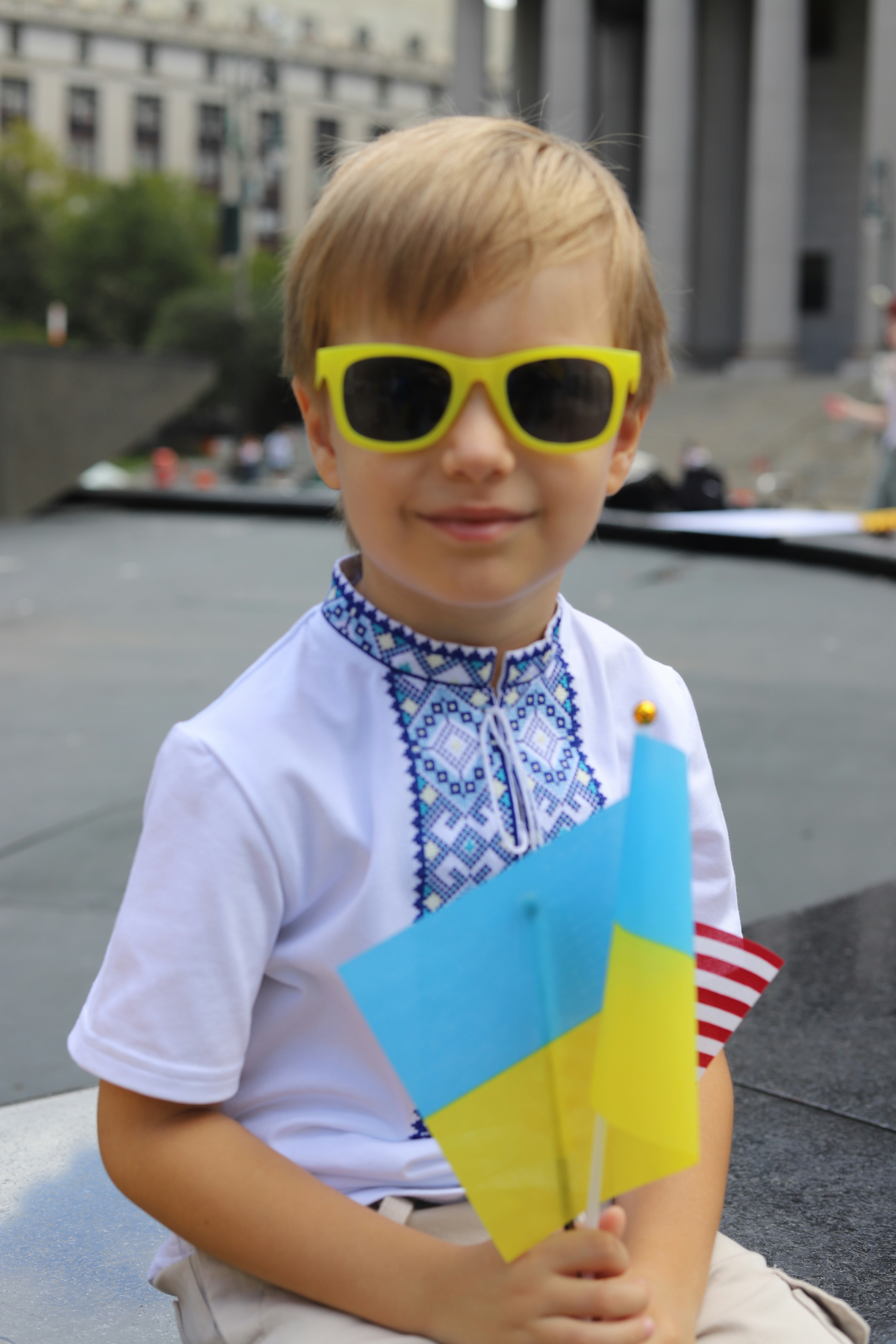 Child in yellow sunglasses holding flags - Free Photo on Unsplash