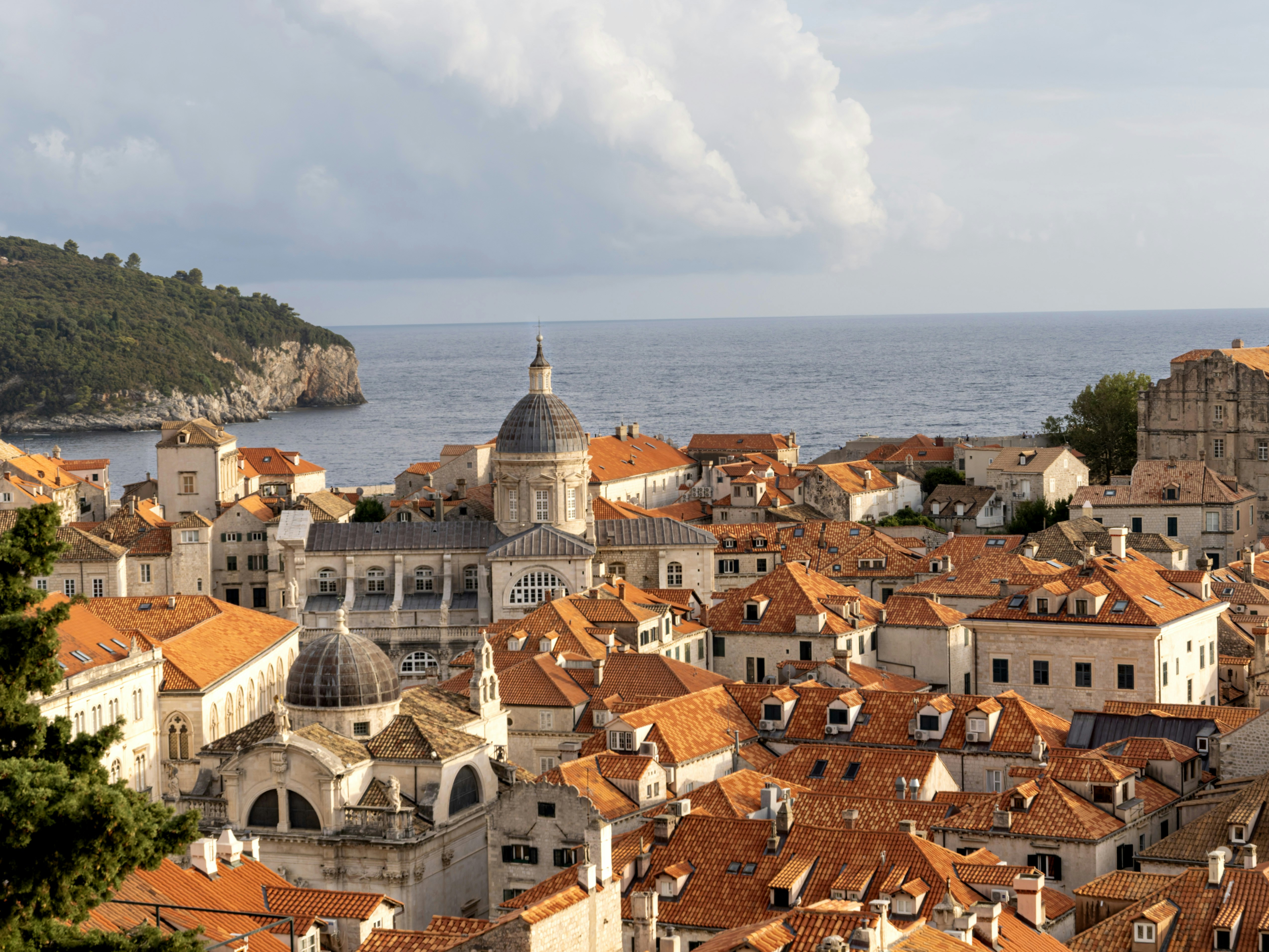 Orange tiled roofs of Dubrovnik overlooking the Adriatic Sea under a cloudy sky