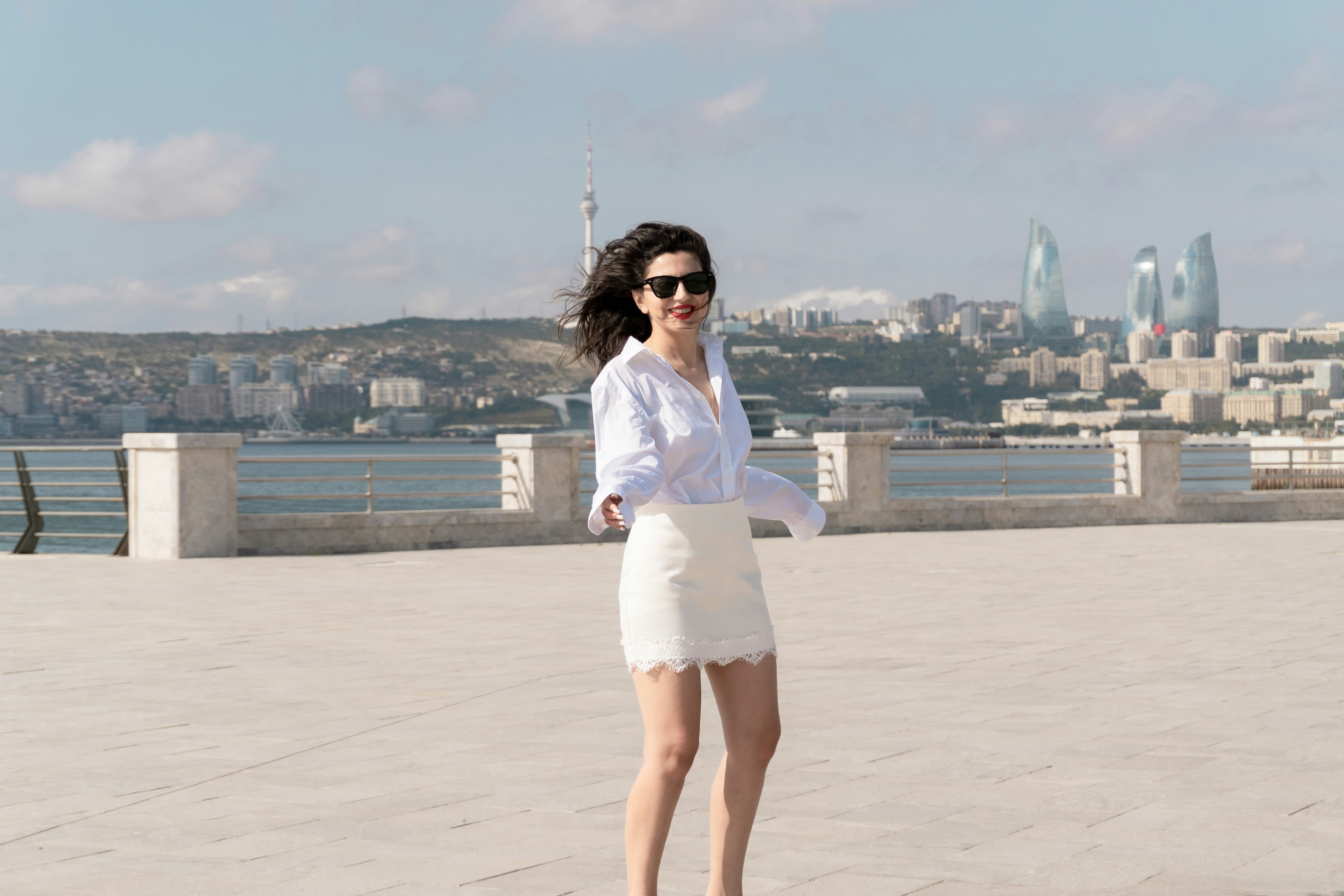 A woman in a white shirt and skirt on the Baku Boulevard in Azerbaijan