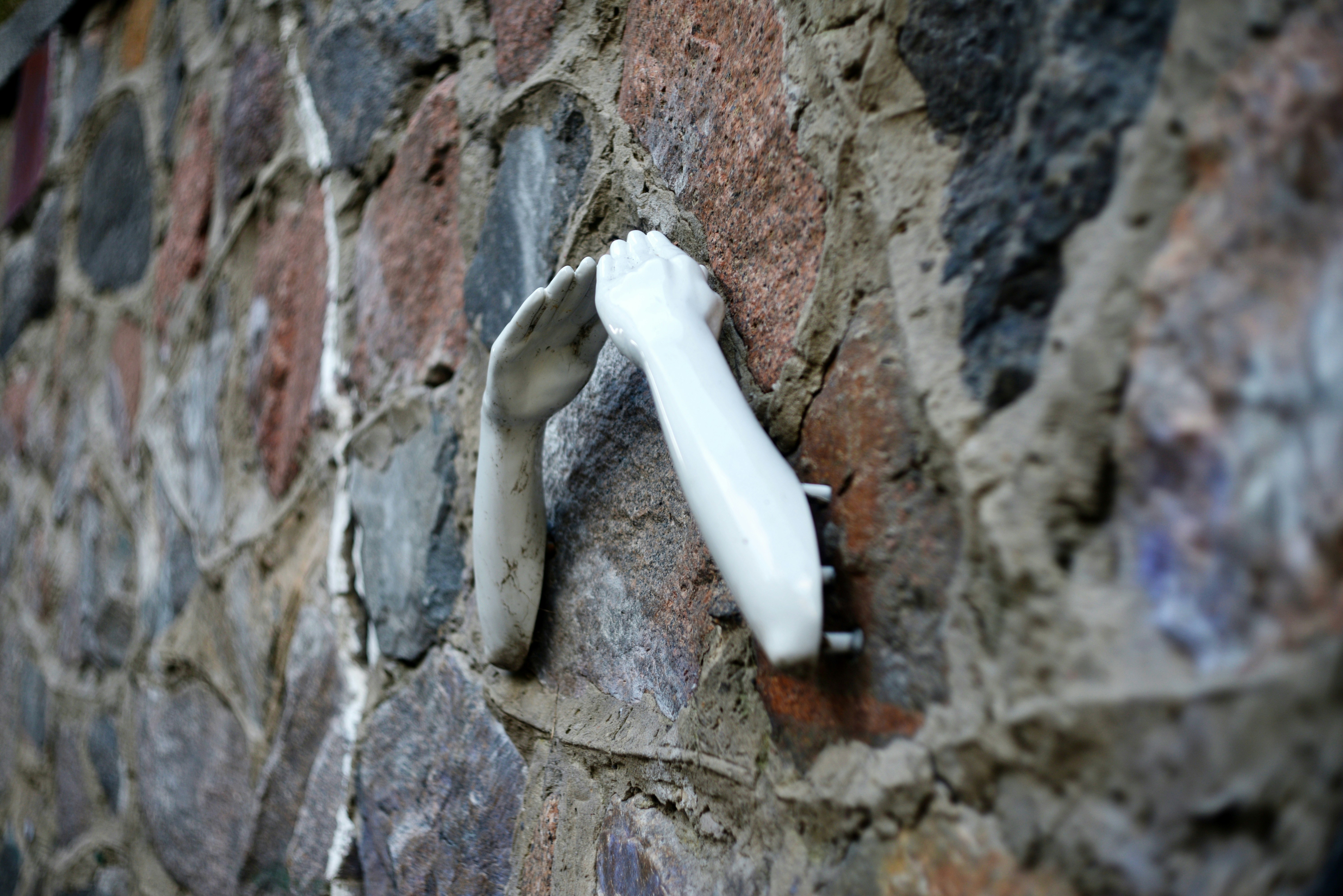 Mannequin arms on stone wall - Free Photo on Unsplash