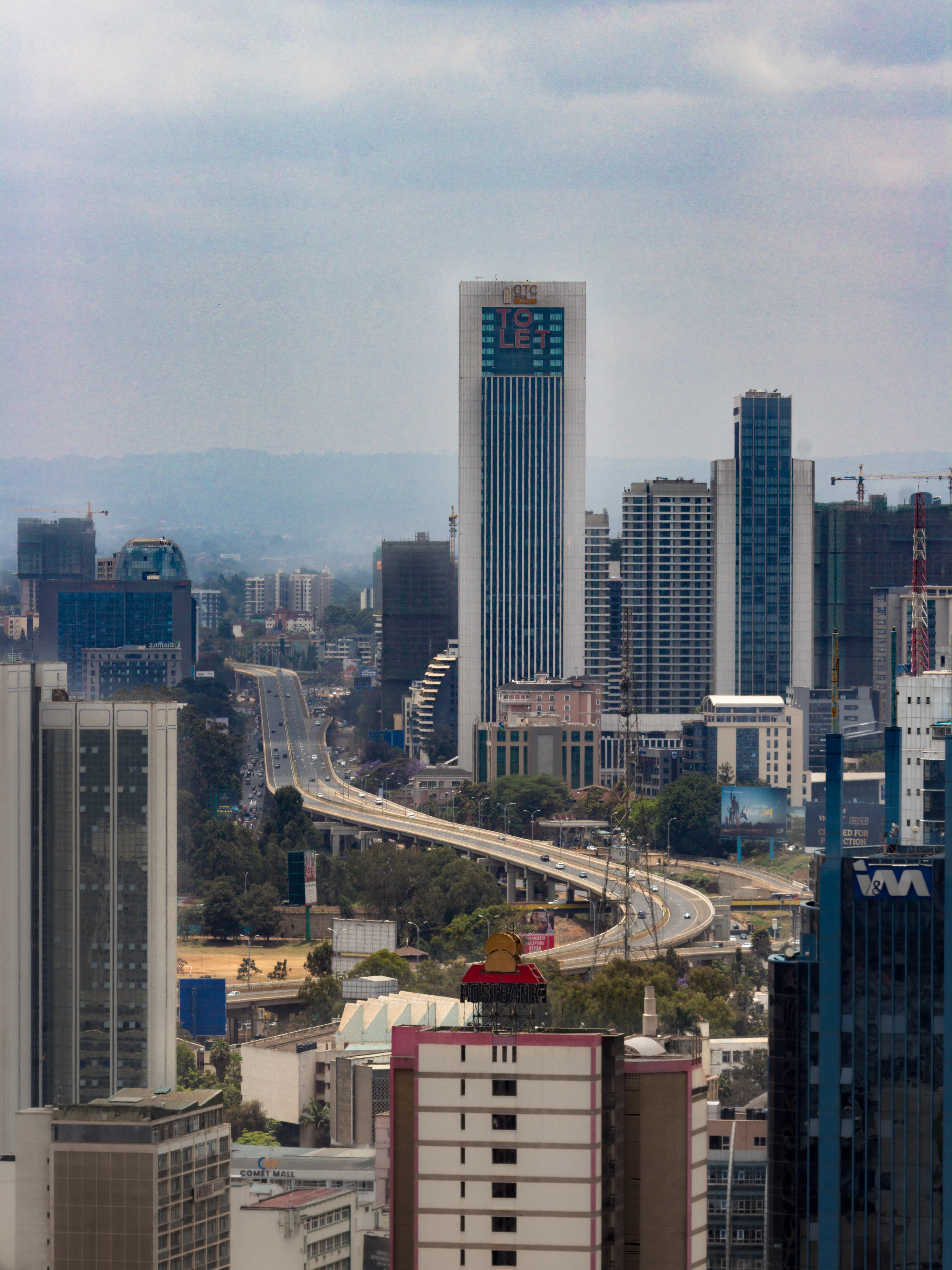 Highway curving through the Nairobi skyline