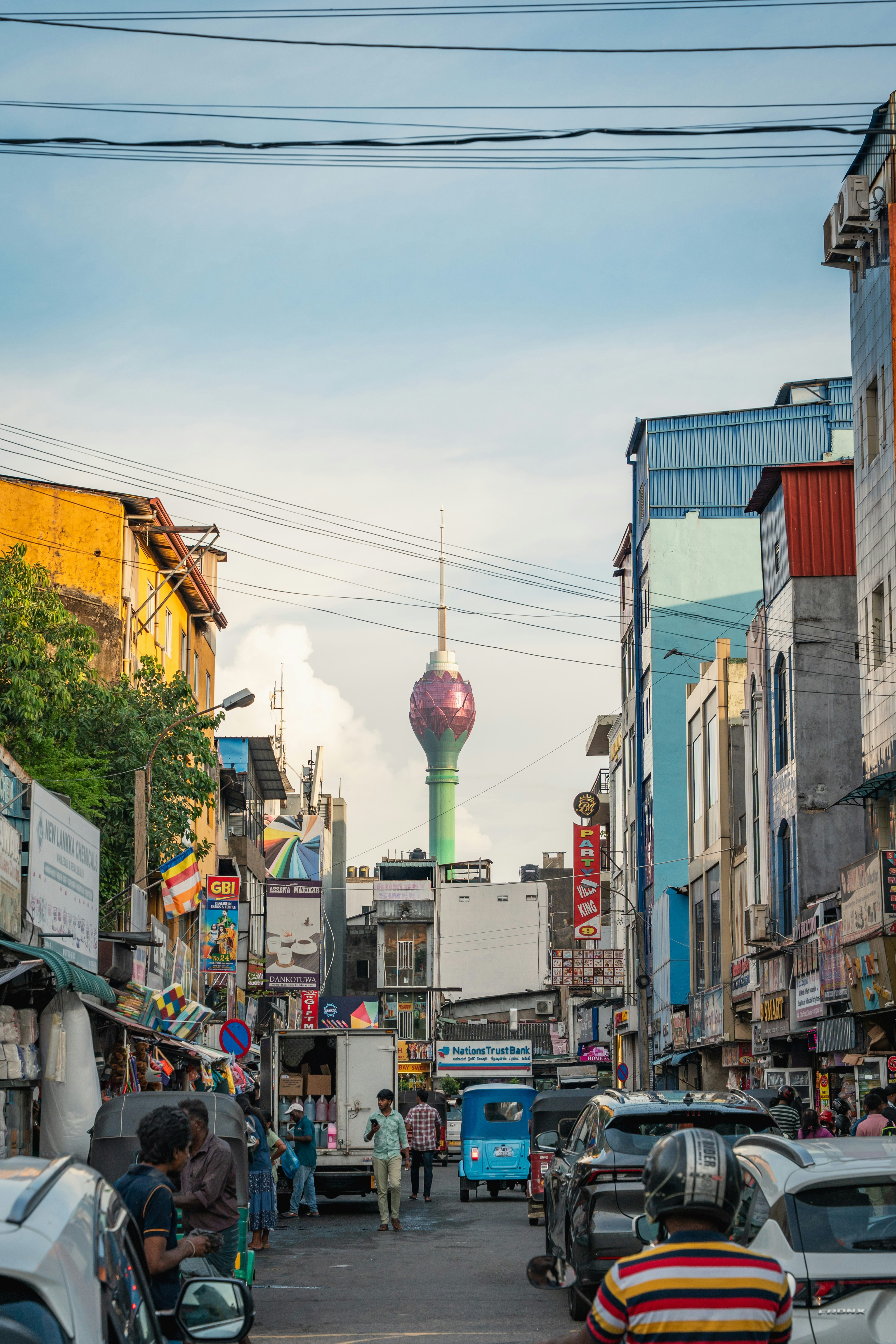 The Lotus Tower rising above a busy street in Colombo with cars and pedestrians