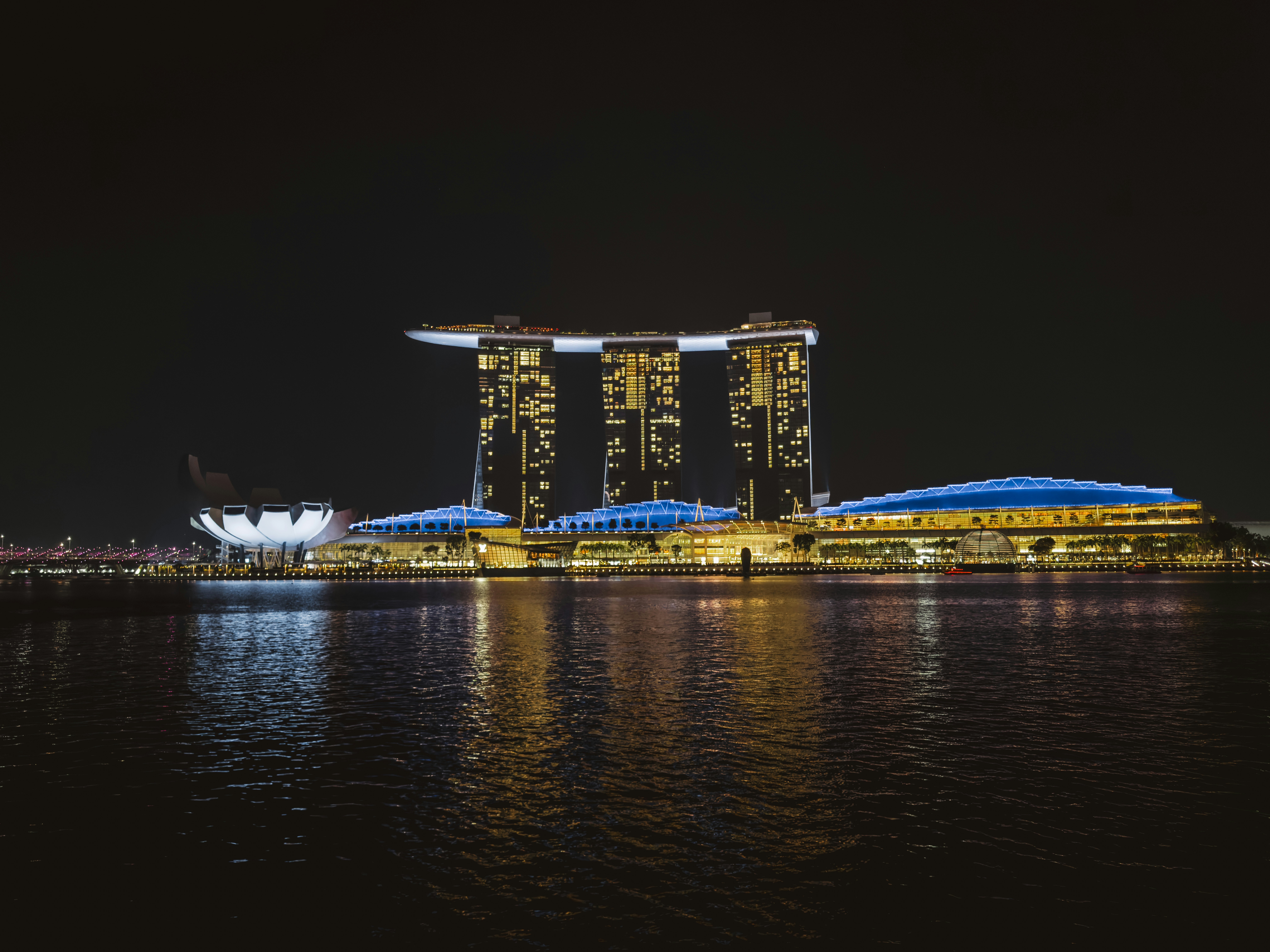 Marina Bay Sands hotel and ArtScience Museum illuminated at night in Singapore