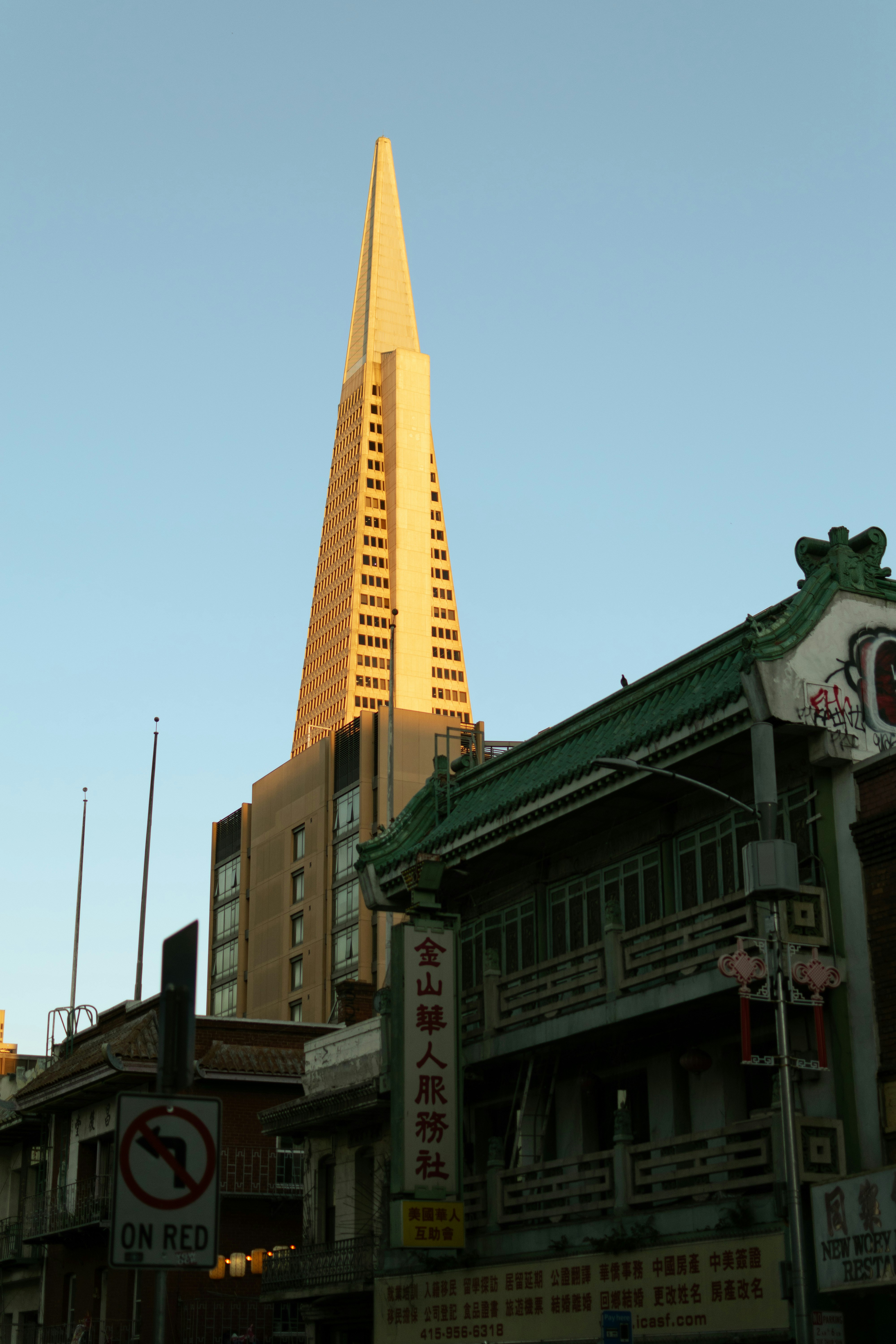 The Transamerica Pyramid rising above traditional architecture in San Francisco at golden hour