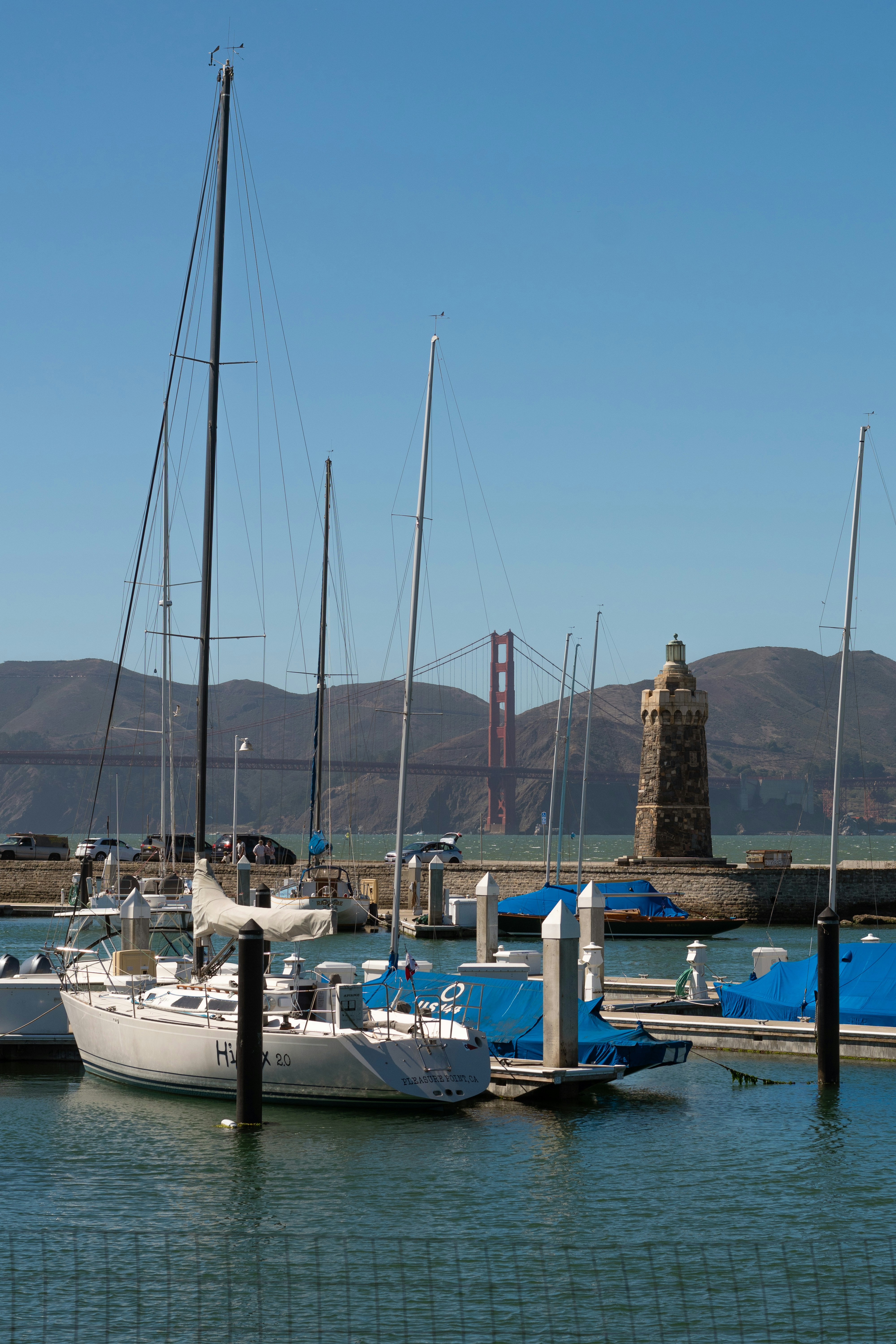 Sailboats moored at a marina with the Golden Gate Bridge in San Francisco