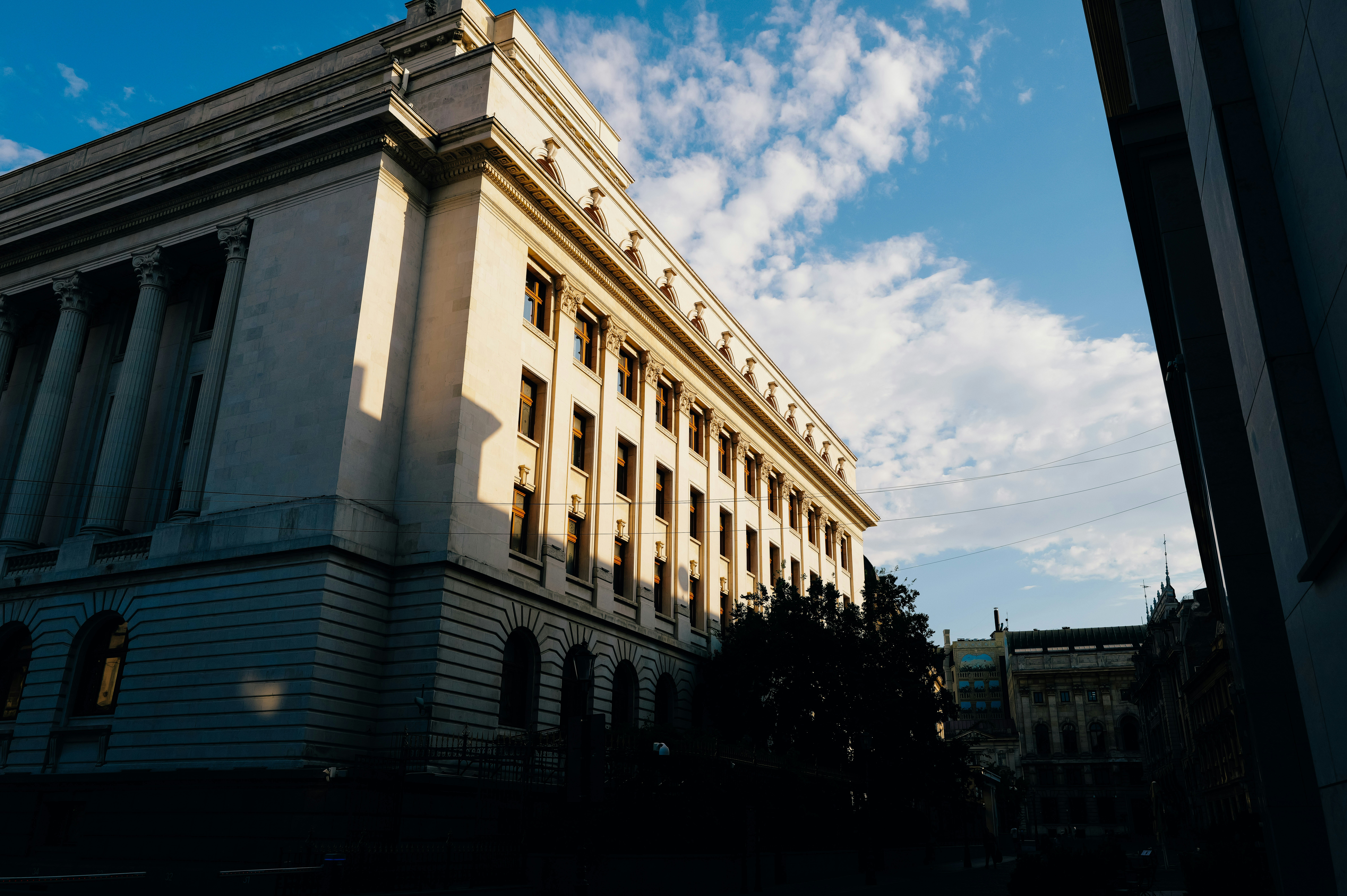 Neoclassical public building with columns against blue sky