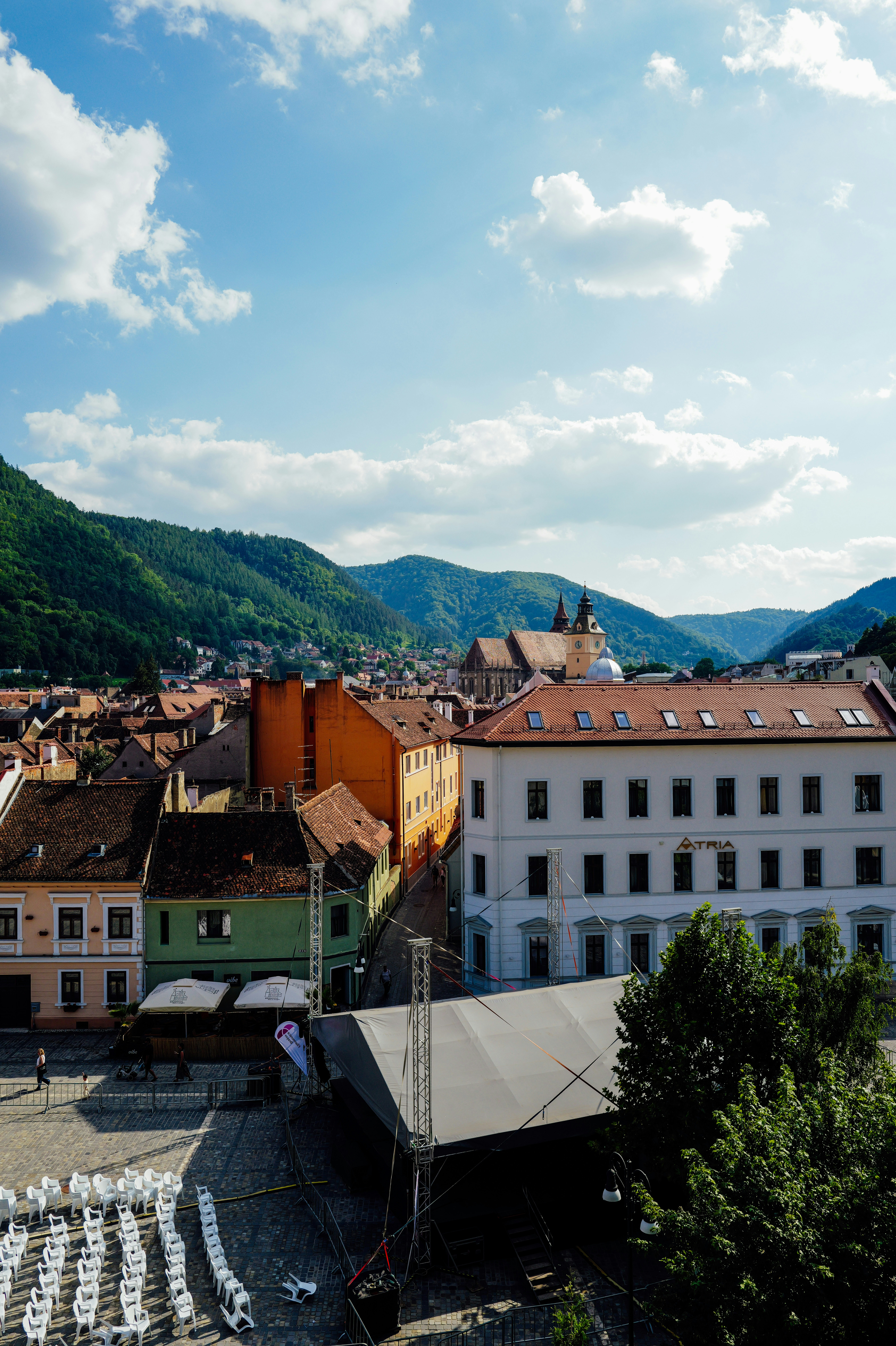 A town square with rows of white chairs before a stage in Brasov, Romania