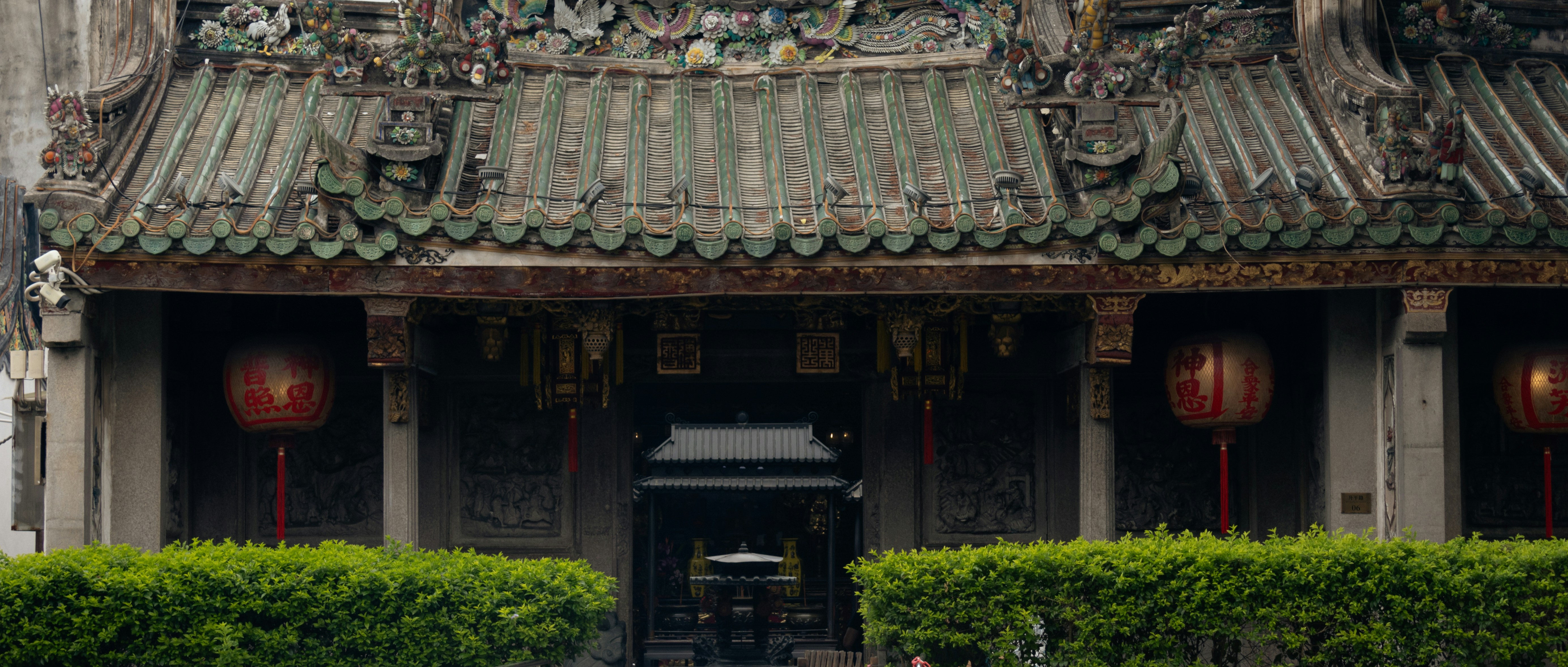 A traditional temple with green tiled roof and red lanterns in Tainan